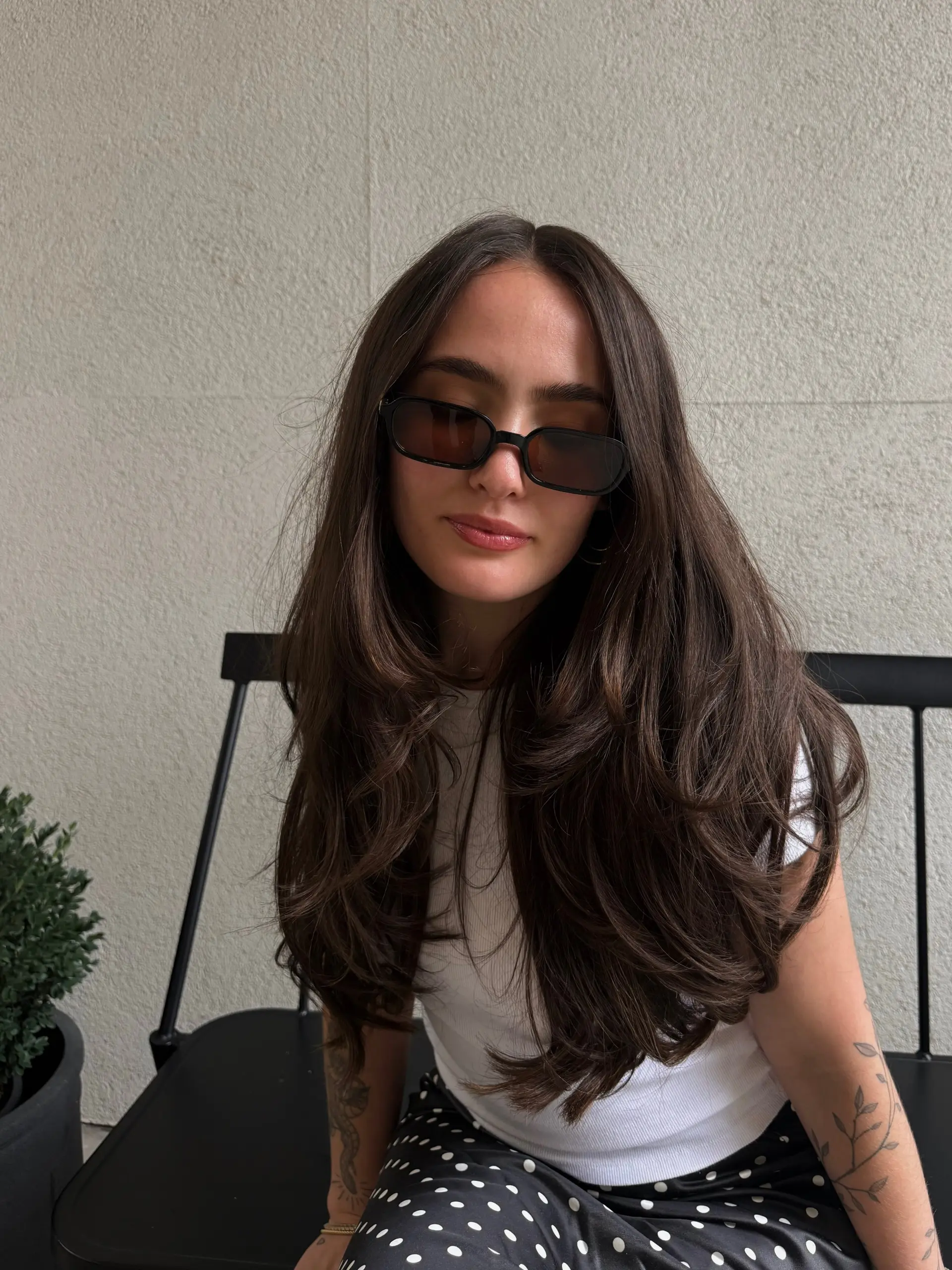 Long, lush dark brown hair styled with heavy layers and a bouncy, voluminous blowout. 1