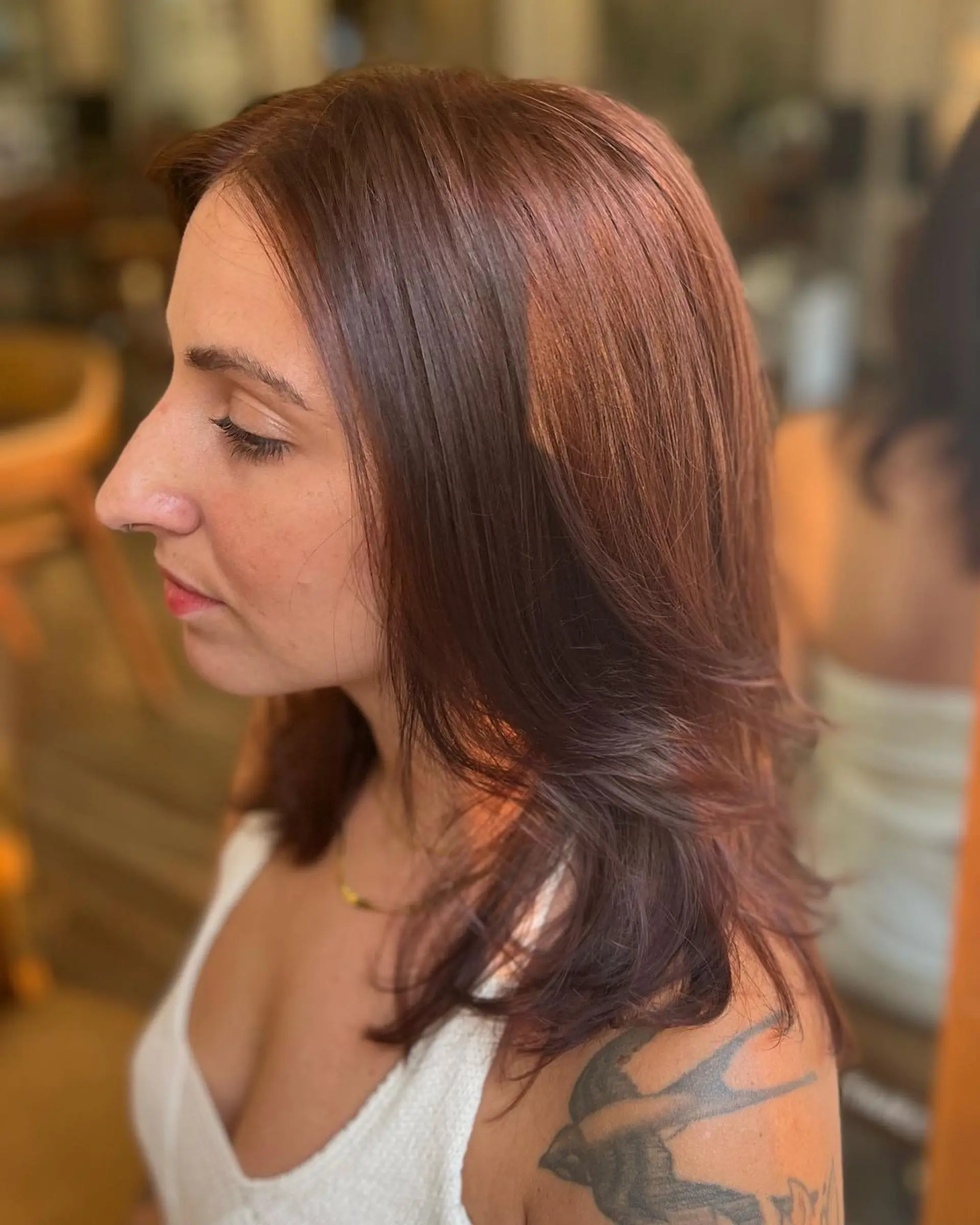 Medium-length, chestnut-colored hair styled in soft waves with a side part and subtle layers, showcasing natural shine and health. 1