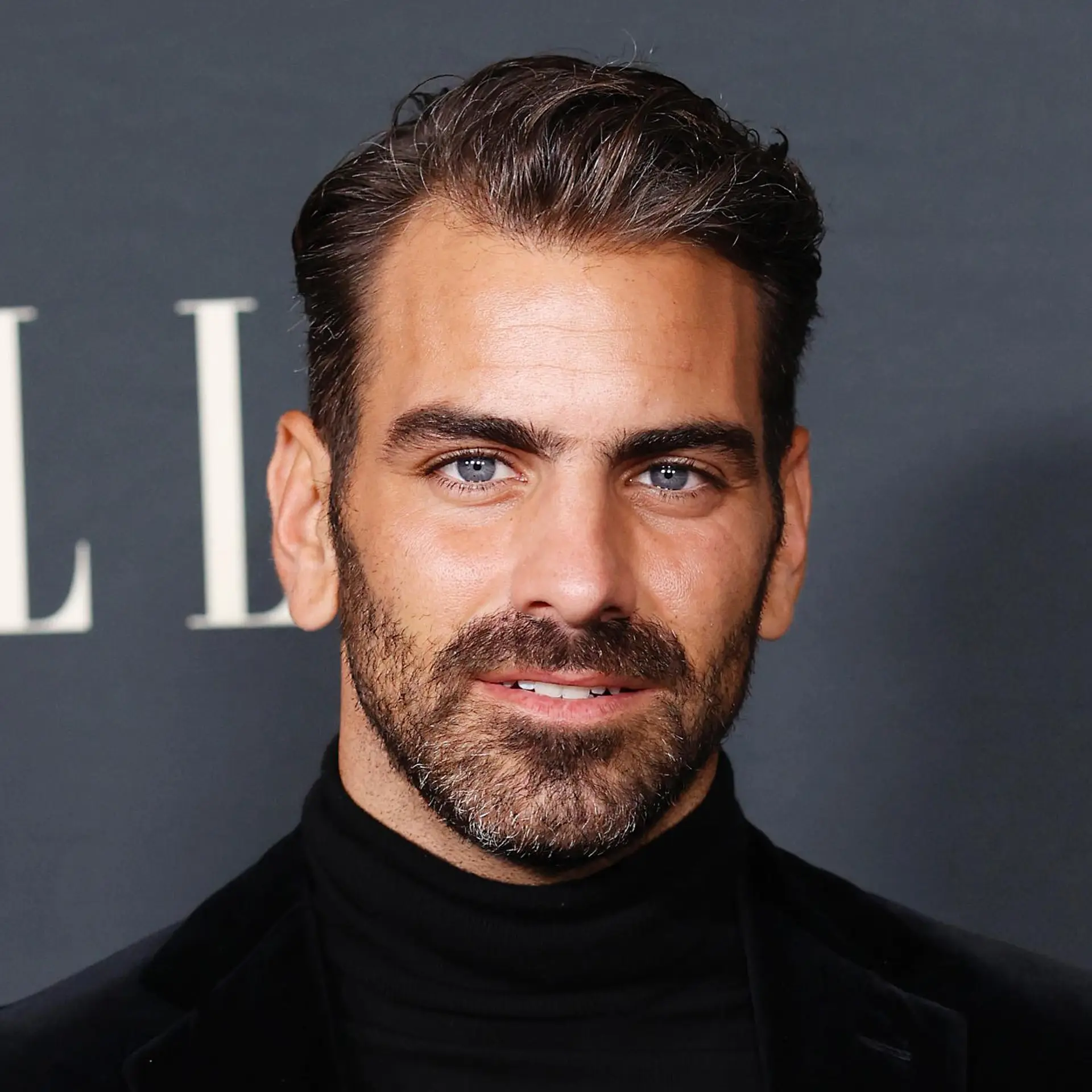 A refined men's cut styled up and swept back with natural texture and soft tapered sides. 1