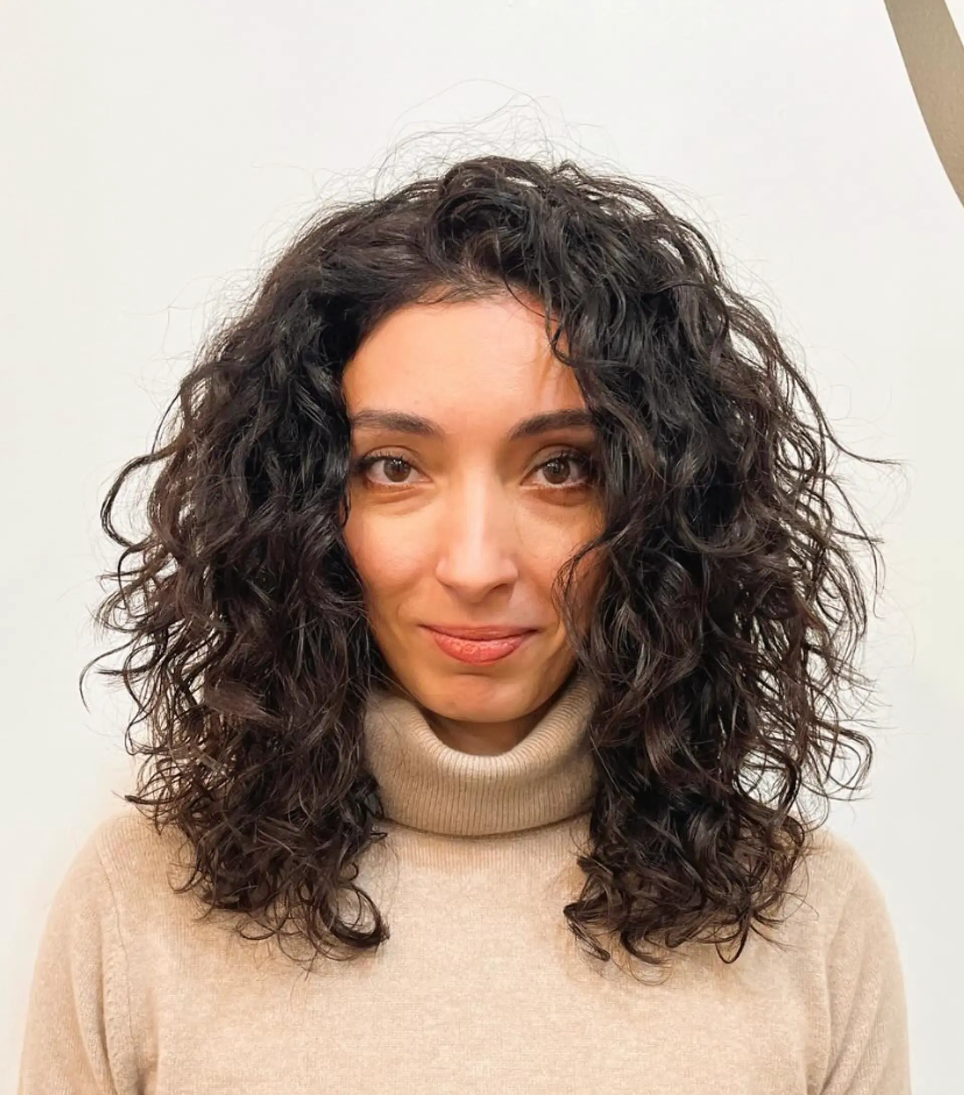 Medium-length dark brown curly hair with voluminous, layered curls that are natural, bouncy, and frizz-free.

Cut and style by @juliamannino_hair 1