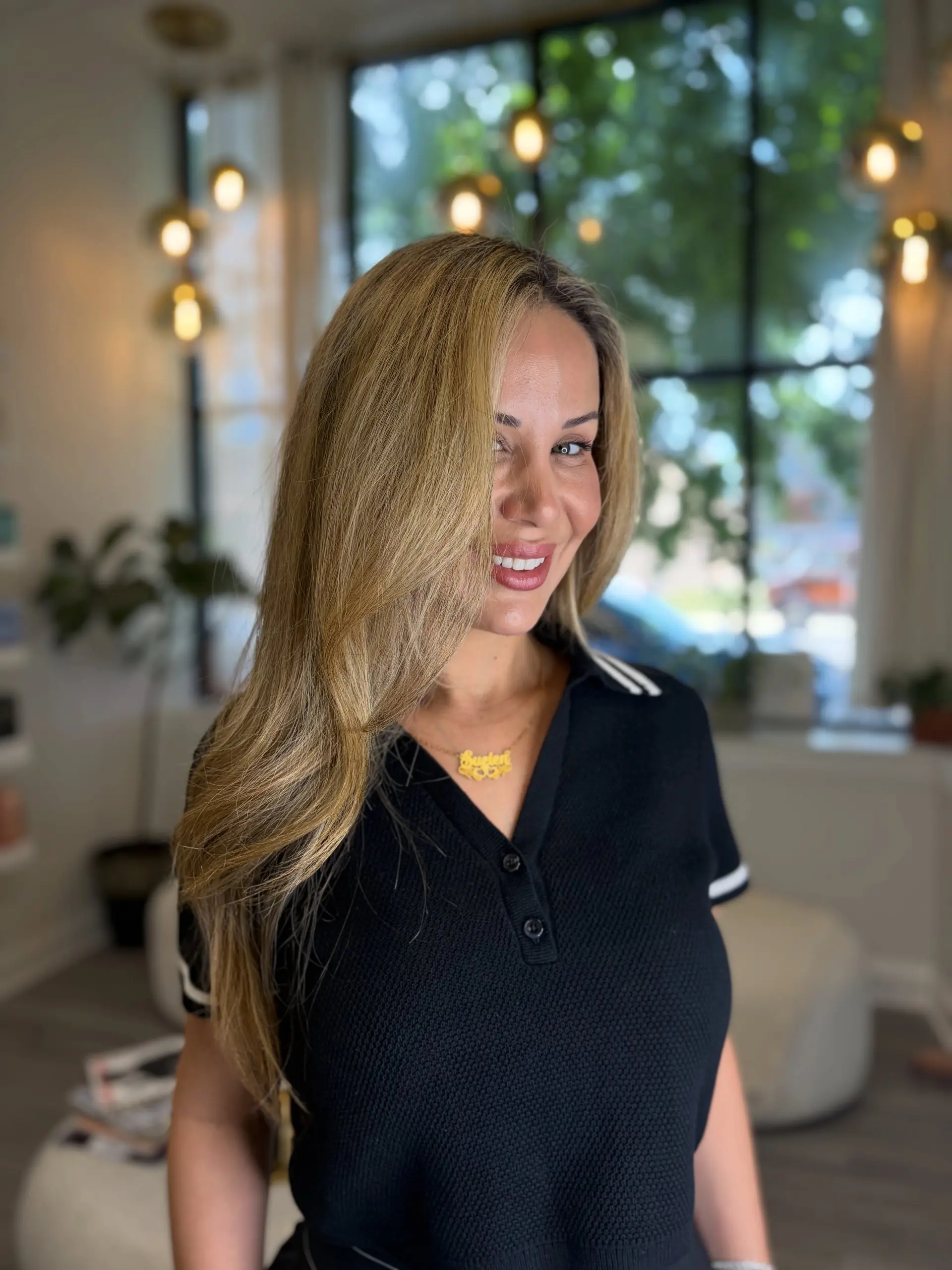 A side-parted, smooth blowout with soft outward movement, framing the face in glowing honey blonde tones. 1