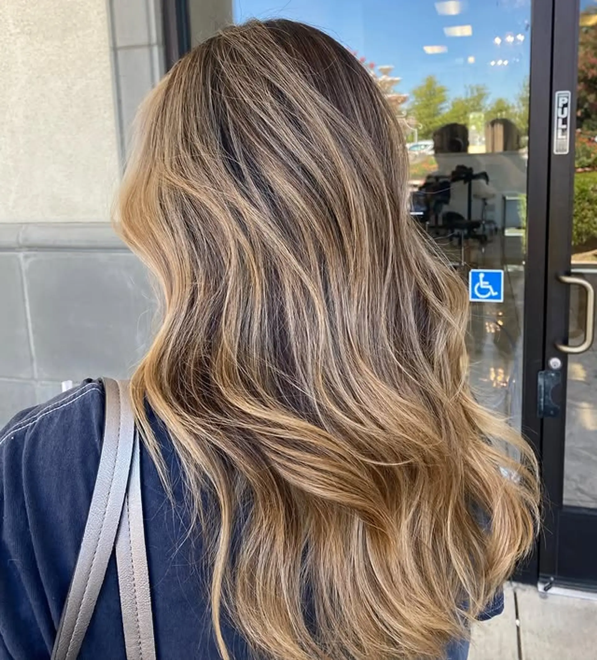 Long, wavy hair with a dimensional blonde balayage. 1