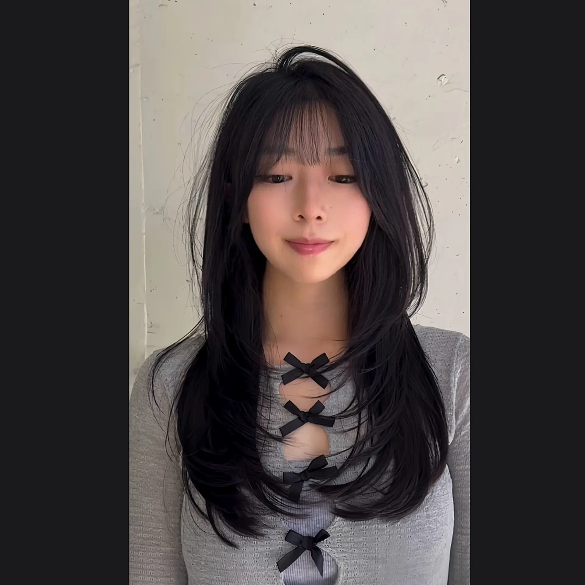 A long layered haircut with face-framing layers and see-through bangs. 1