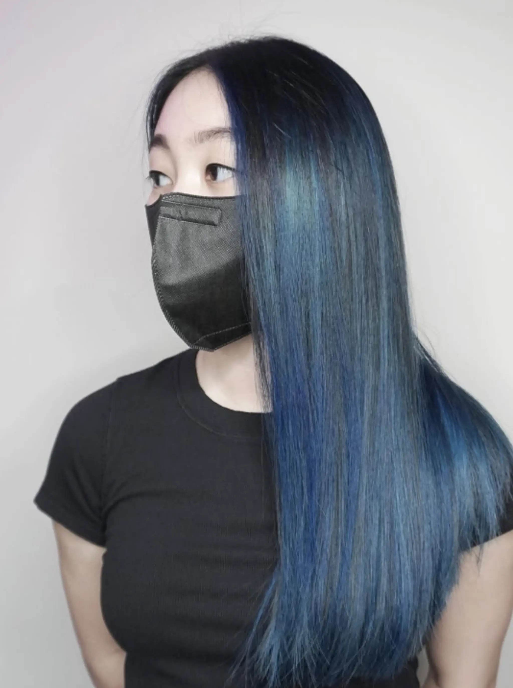 Long straight hair with vibrant ocean blue highlights.