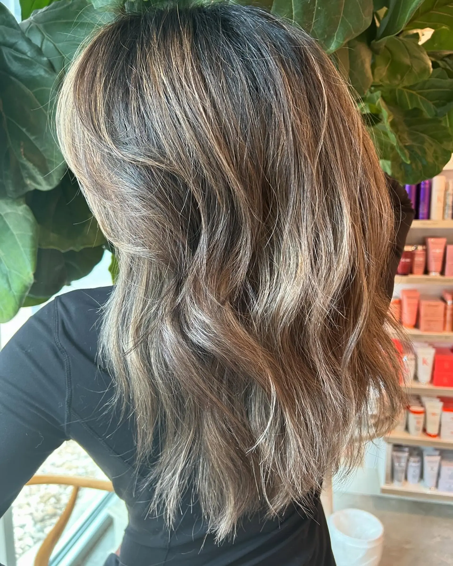 Long cool-toned bronde hair with dimensional highlights styled into soft, effortless waves. 1