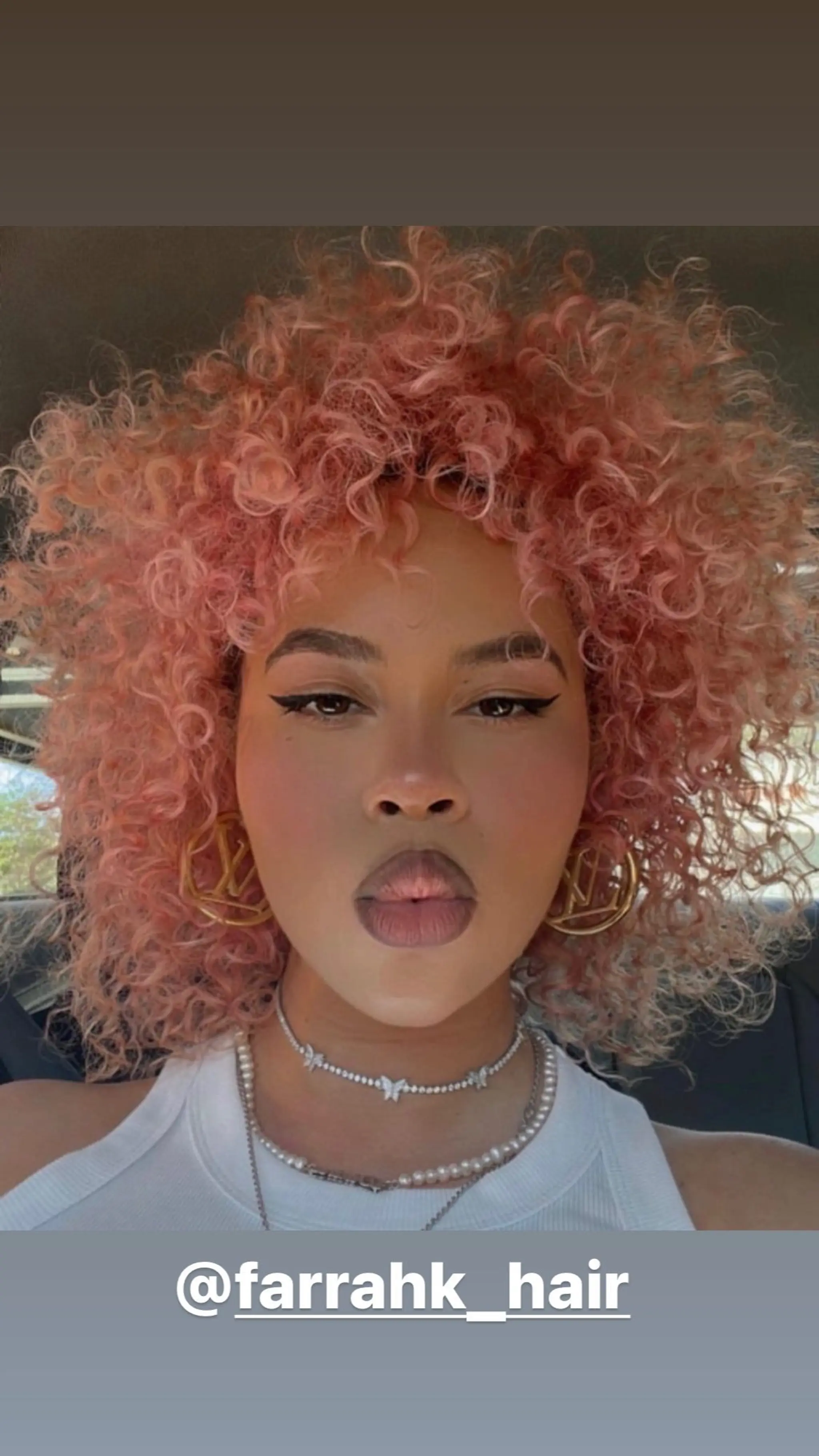 A curly bob haircut with defined curls.