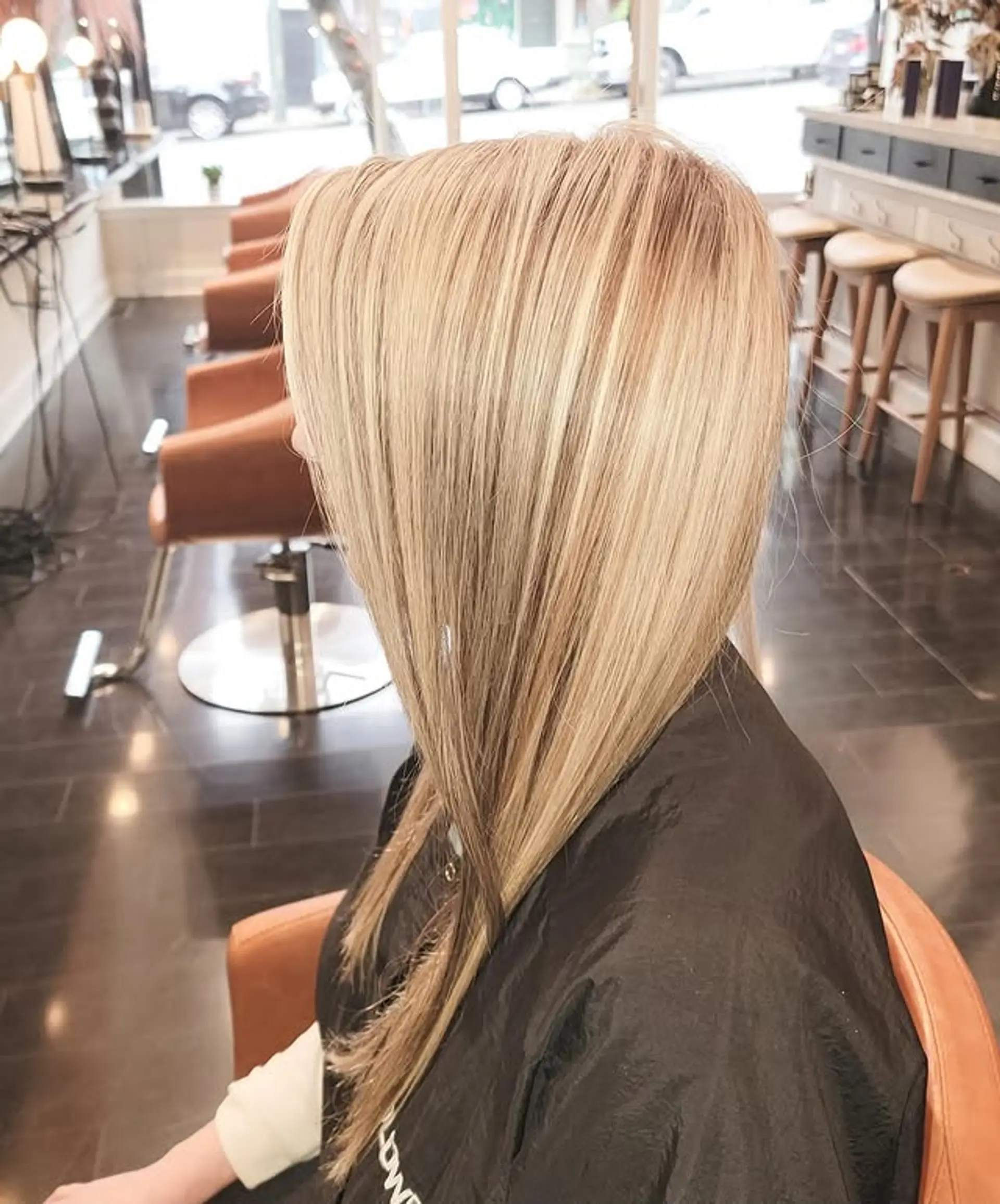 A long, sleek, and straight hairstyle featuring a gorgeous honey blonde balayage with subtly darker roots, creating a natural and dimensional blonde effect. 1