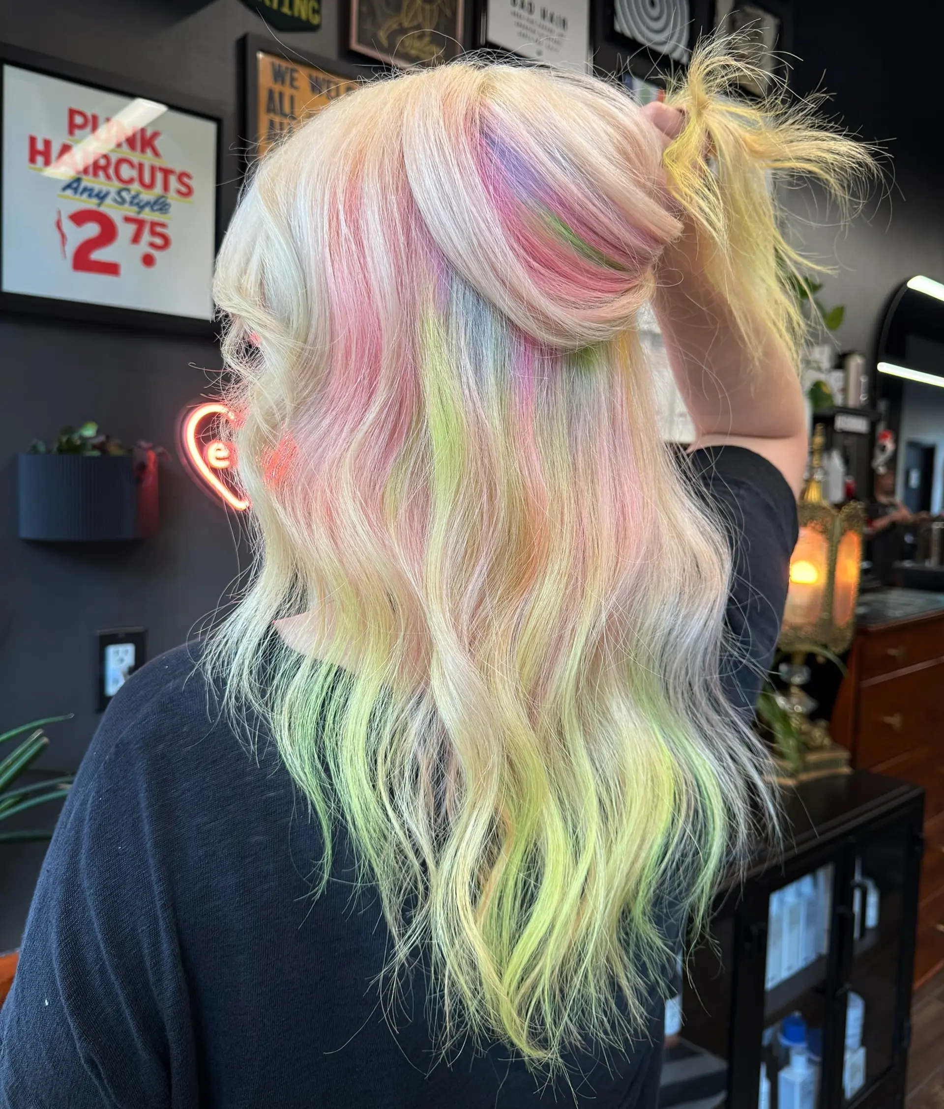 Long wavy platinum blonde hair accented with a multi-colored pastel tie-dye blend of pink, lime green, and soft lavender. 1