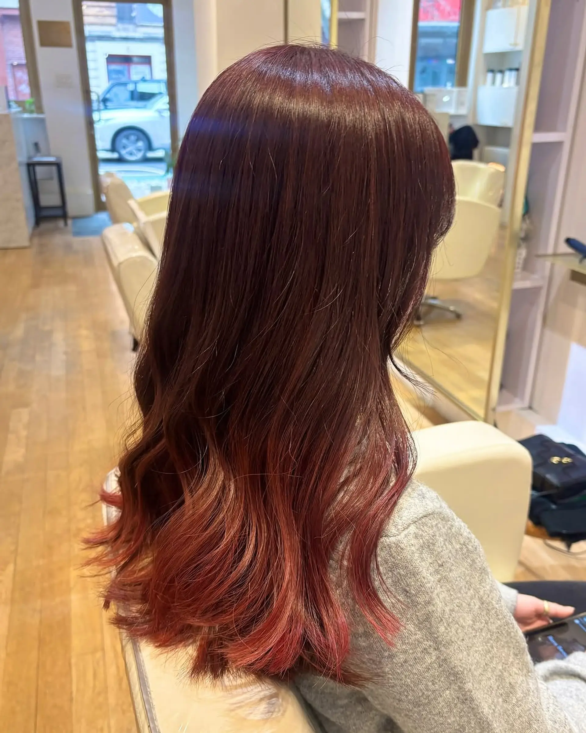 A medium-length hairstyle with an ombre color melt and loose waves. 1