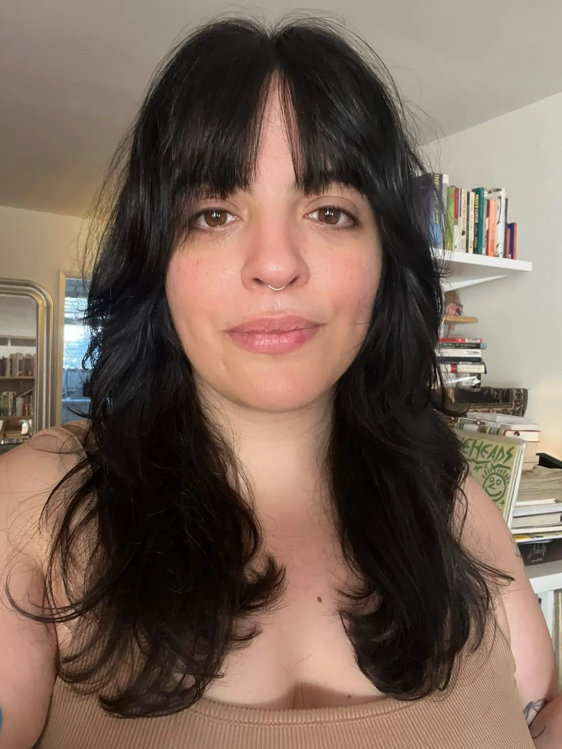 A textured black layered shag haircut featuring face-framing fringe and soft flicked ends. 1