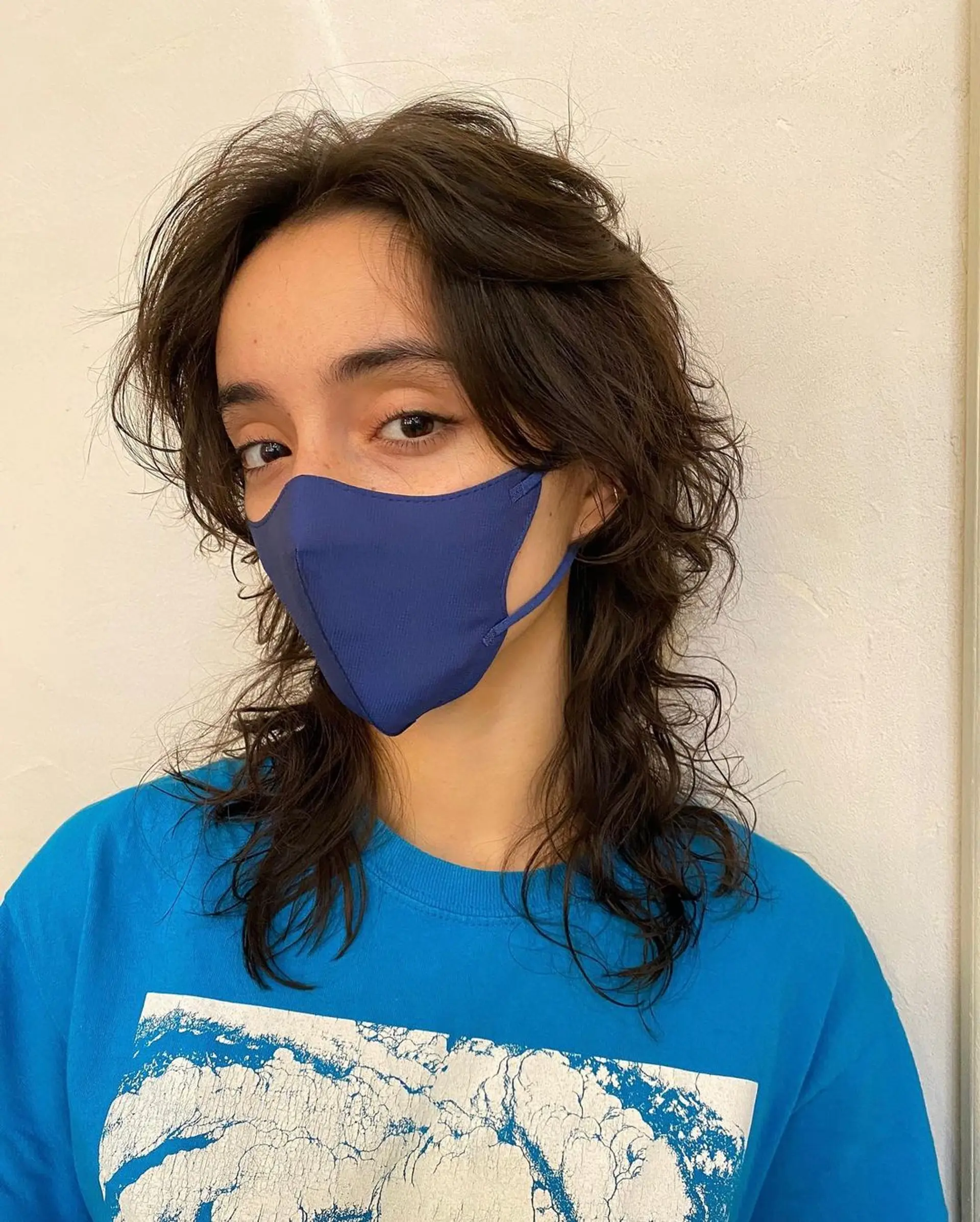 Medium-length, wavy dark brown hair, layered into a shaggy, face-framing style with natural, tousled waves. (Hair by Coco) 1