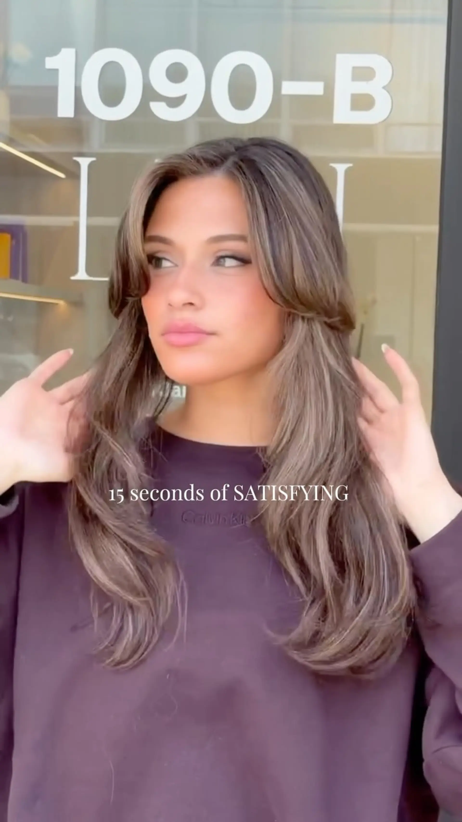 Long ash brown hair cut into flowing layers with bouncy, face-framing curtain bangs and soft movement. 1