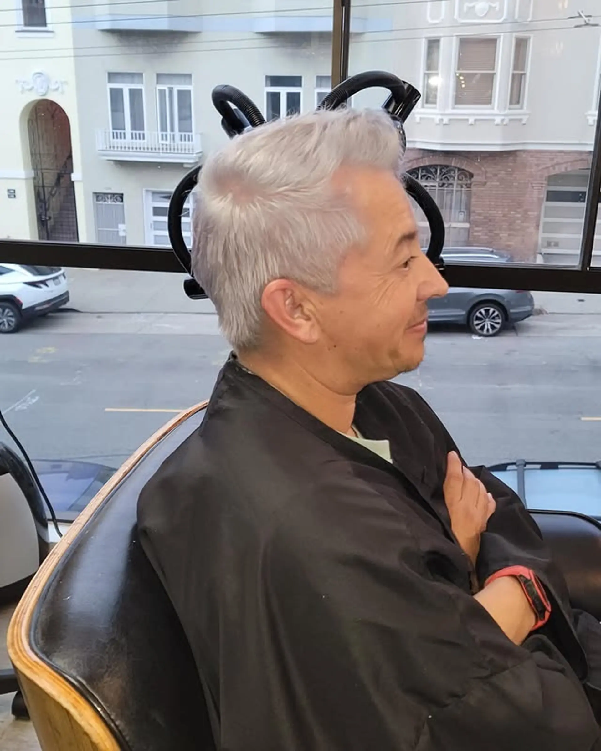 A sleek quiff with longer hair on top styled upwards and backwards, creating volume, contrasted with neatly faded sides and back. 1