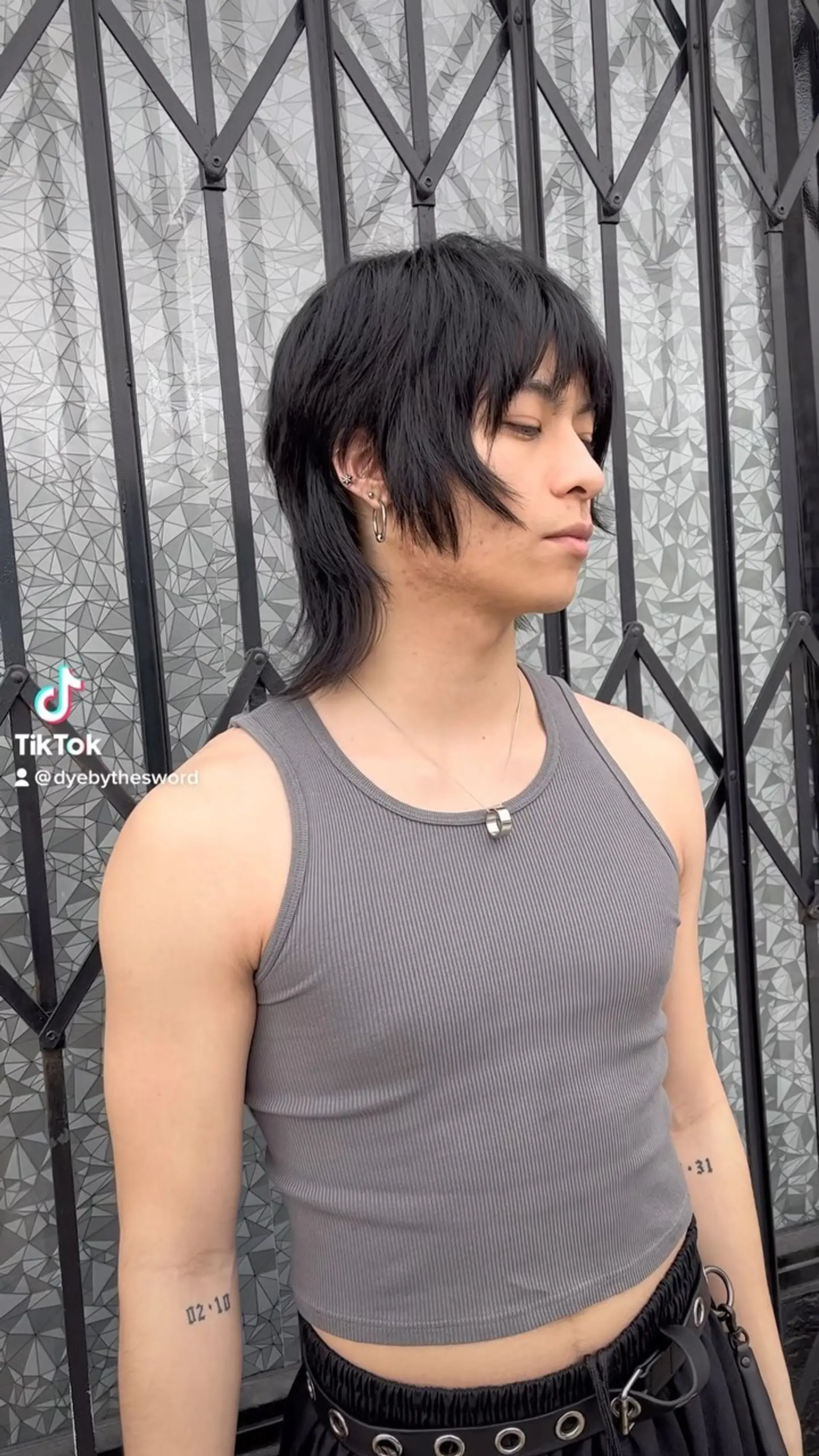 A textured shag mullet featuring piecey bangs, tapered face-framing layers, and a soft length extending down the neck. 1