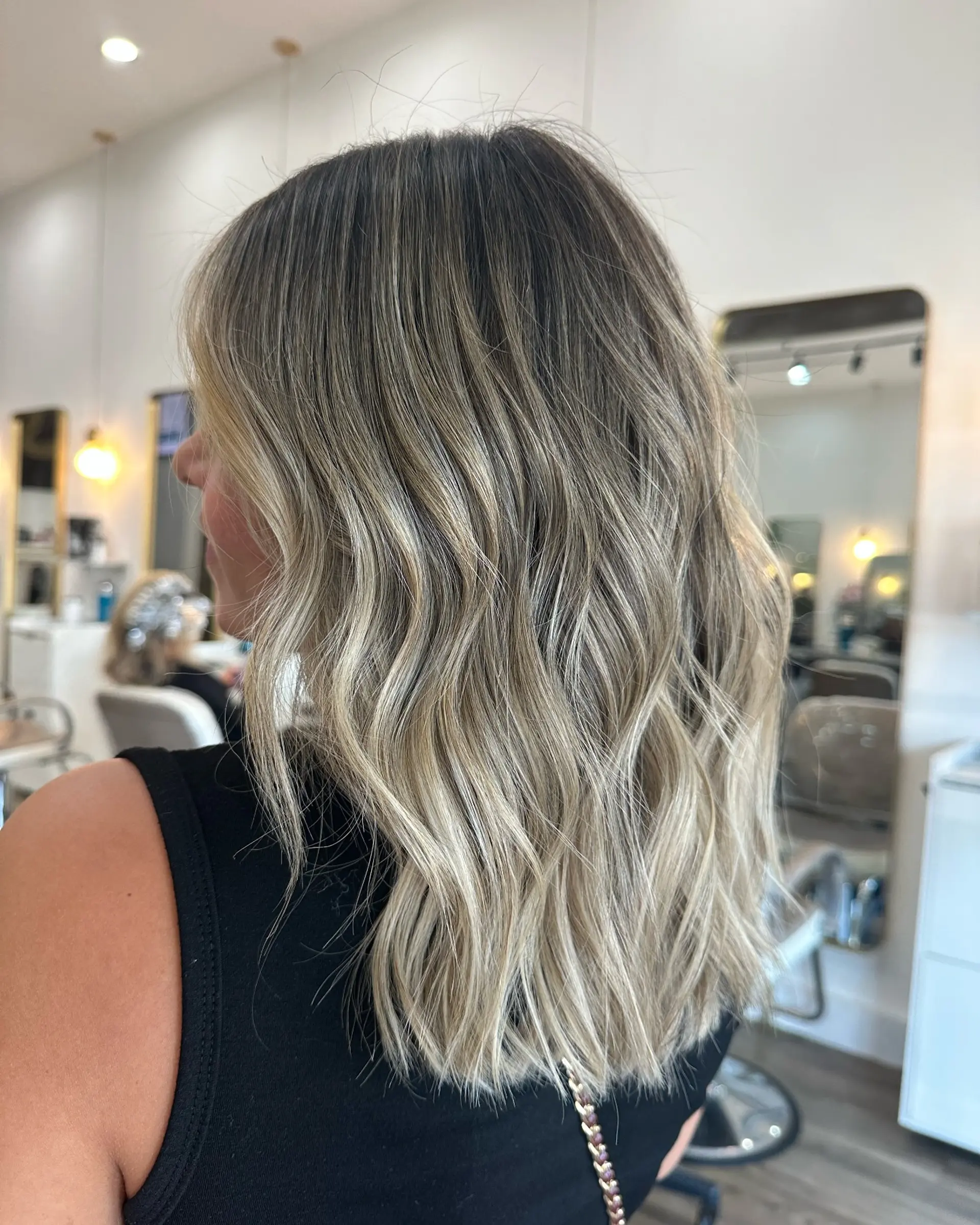 A beachy blonde balayage hairstyle with natural waves. 1