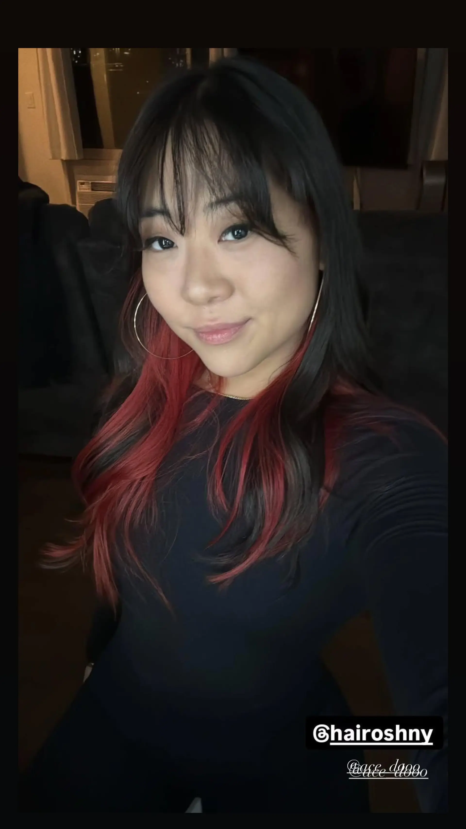 Long, straight hair with a black base and red color dip effect and blunt bangs. 1