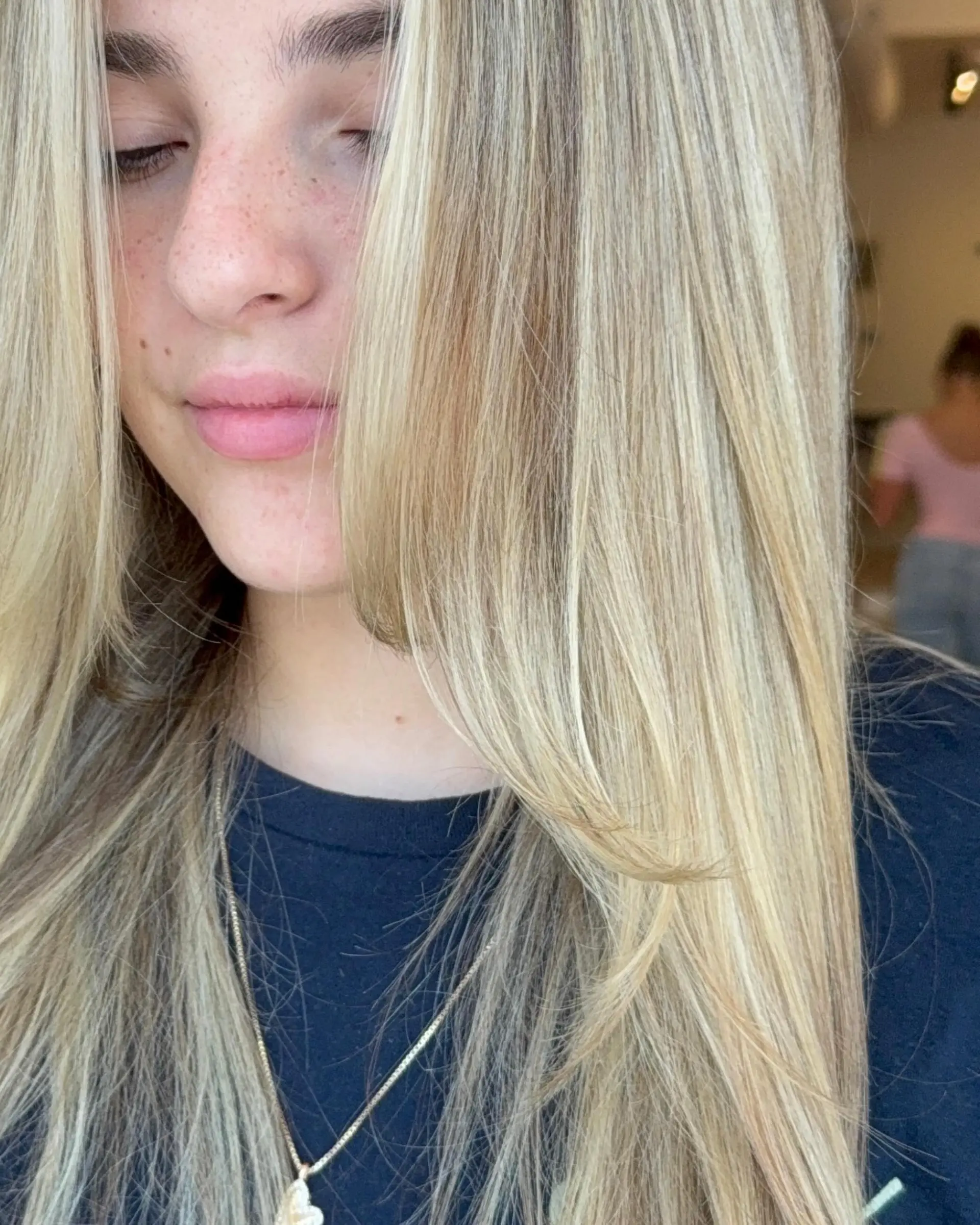 Straight warm butter blonde hair featuring bright face-framing layers and dimensional highlighting. 1