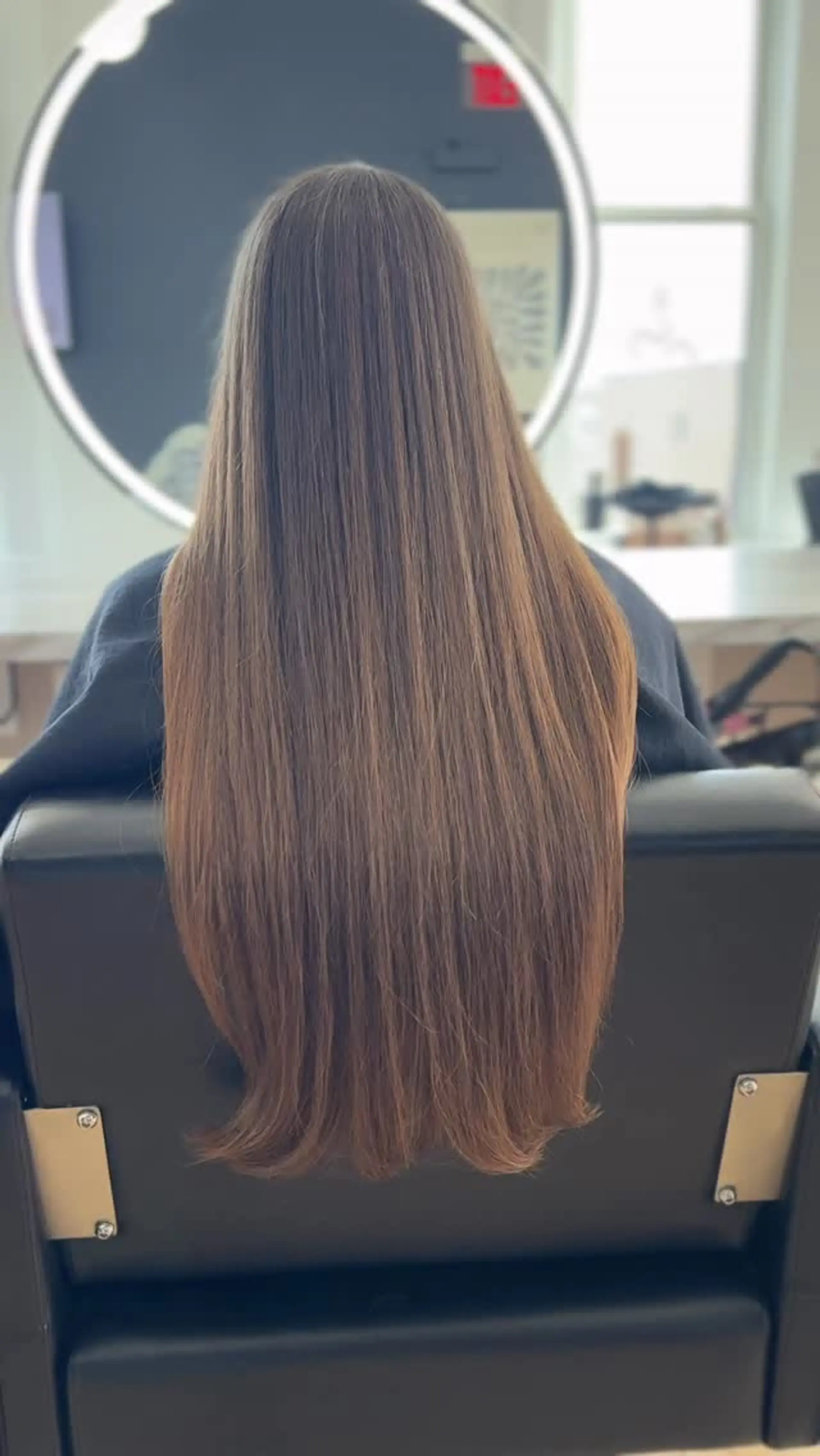 A sleek, smooth blowout on extra long natural hair with neatly trimmed ends. 1