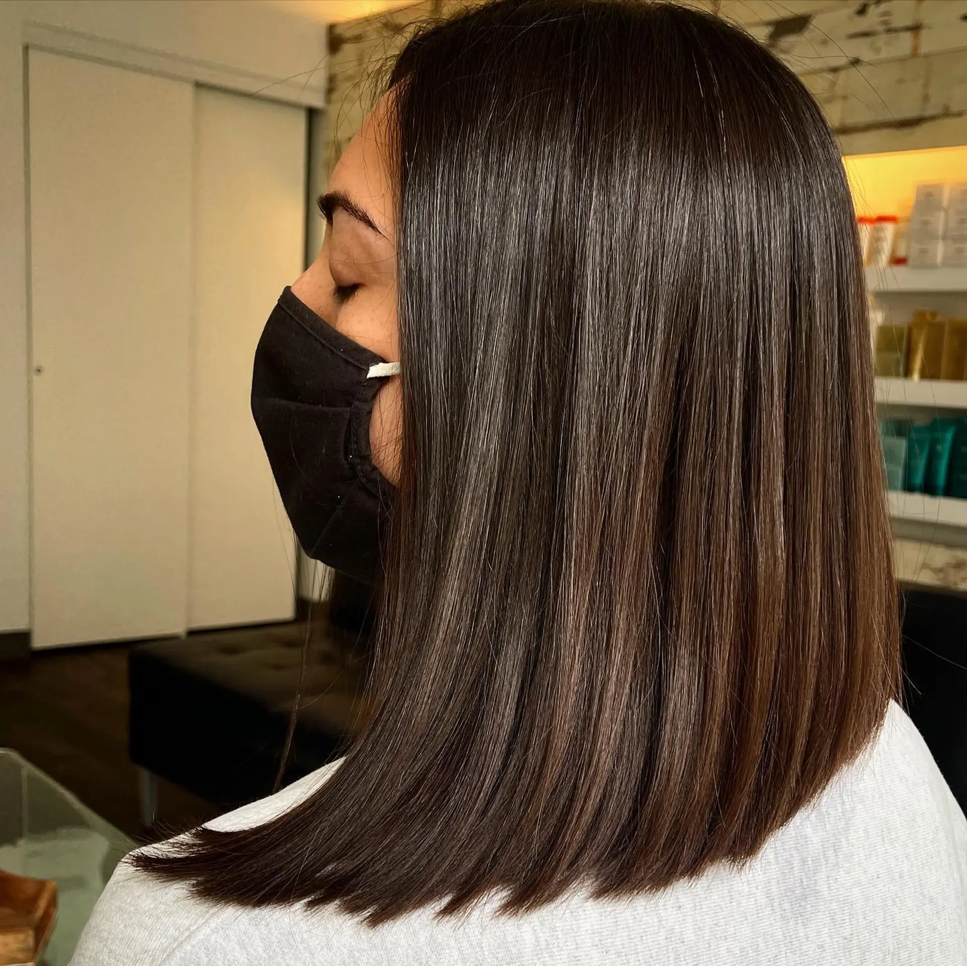 A sleek and glossy shoulder-length blunt long bob (lob) cut straight with clean, sharp ends and ultra-smooth styling. 1