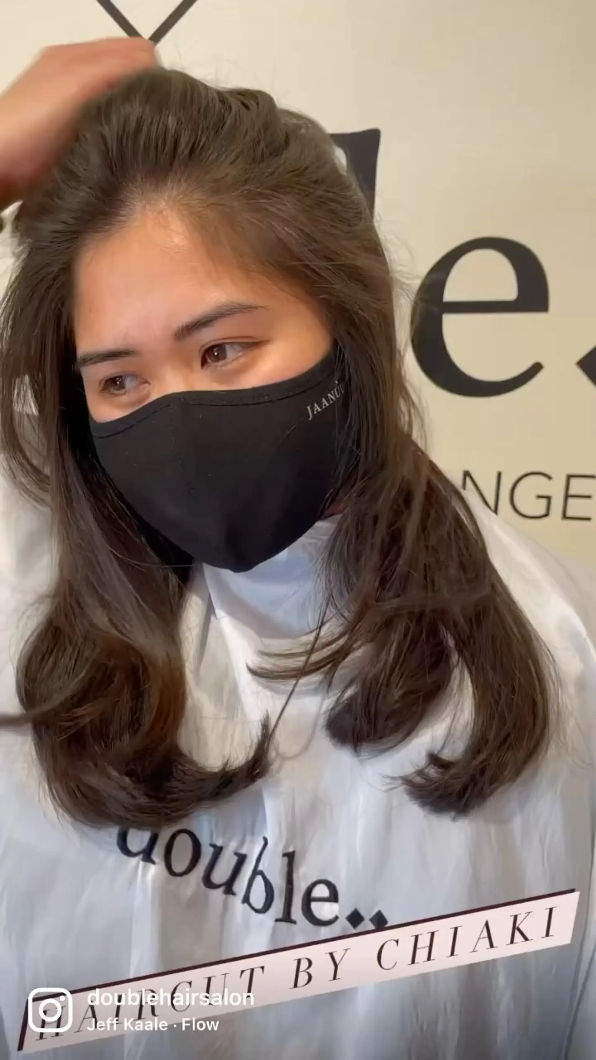 Medium-length layered haircut with soft inward-curling ends and natural volume. 1