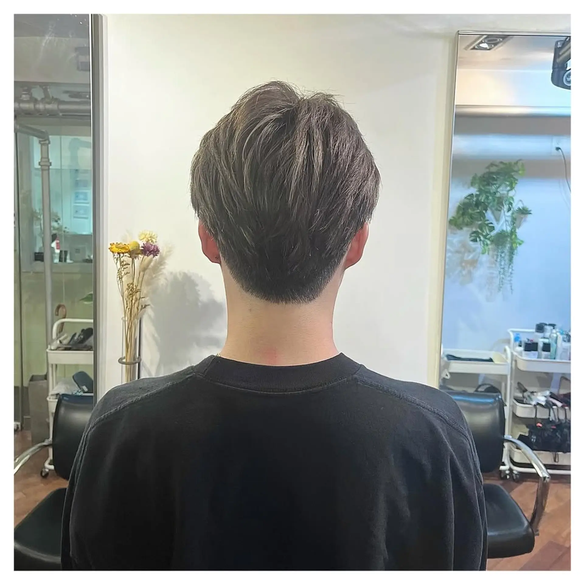 Features a short, faded haircut with textured top and modern silver highlights. 3