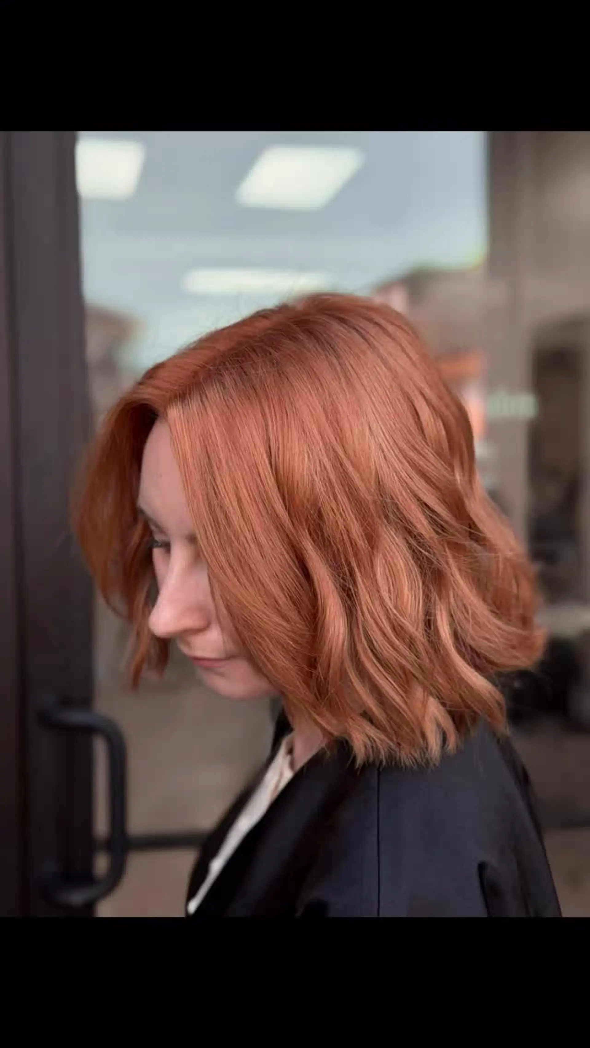 A warm copper lob cut to collarbone length and styled with effortless, soft waves. 1