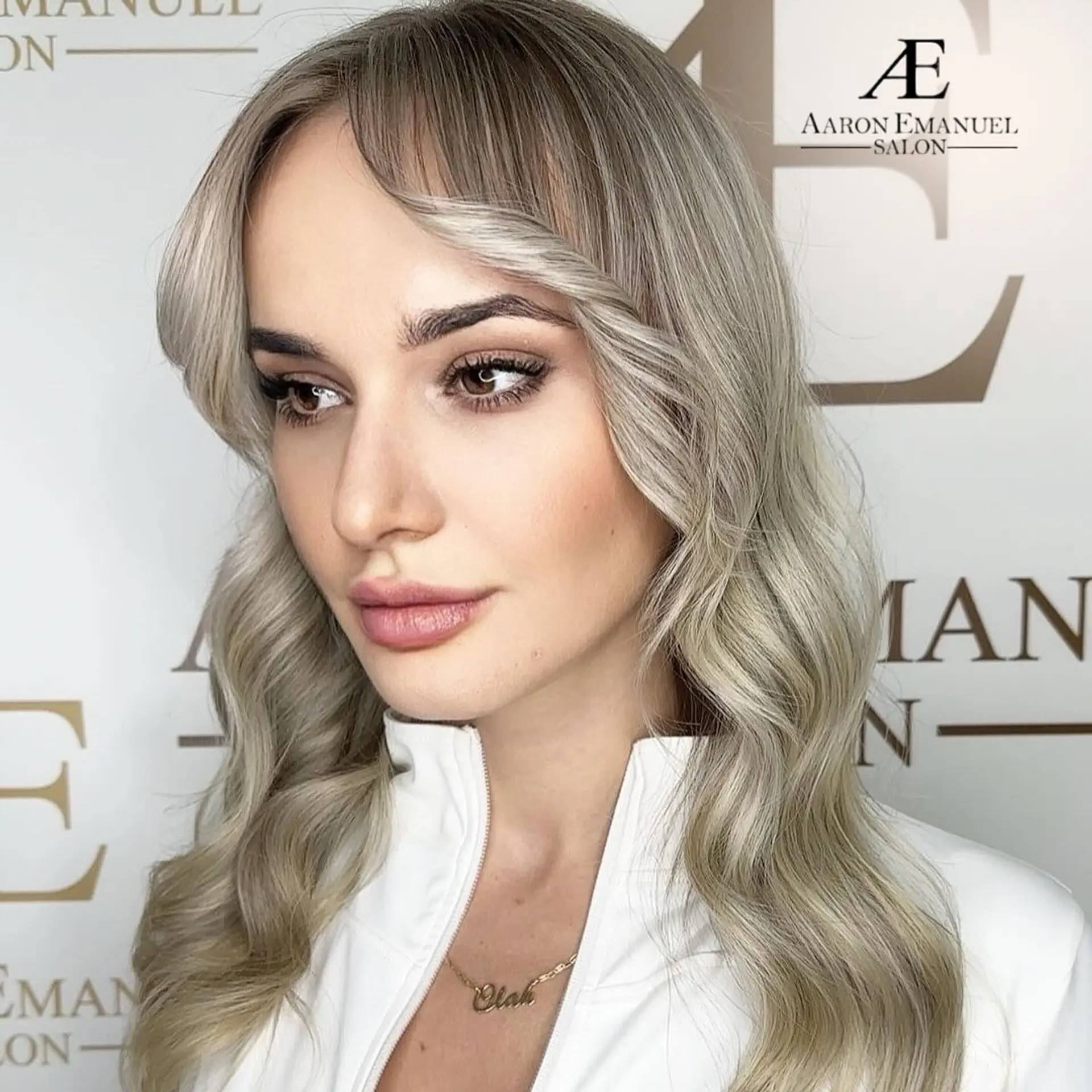 Long, wavy hairstyle with glam waves and curtain bangs. 1