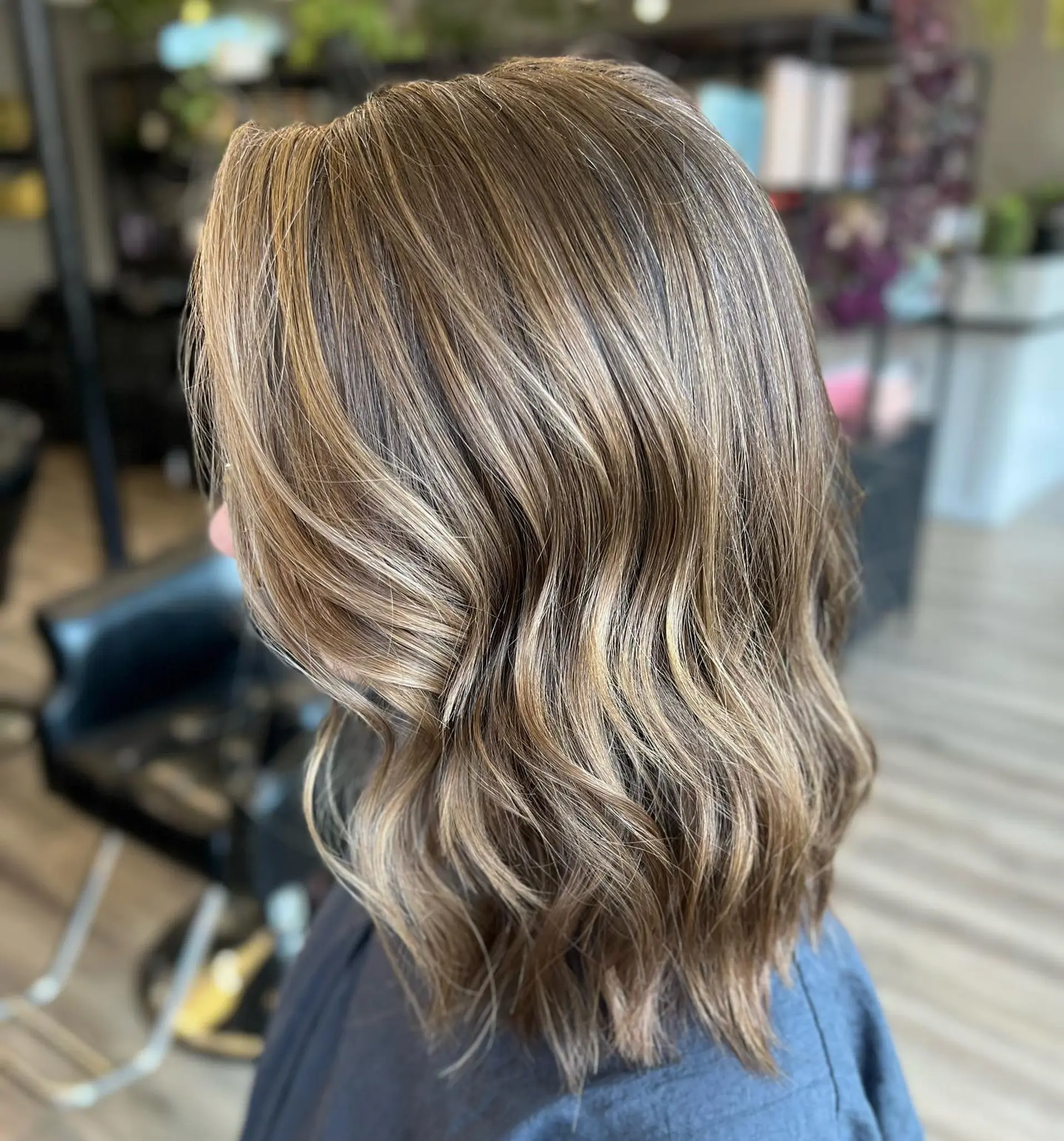 A wavy lob with caramel highlights creating a dimensional color effect. 1