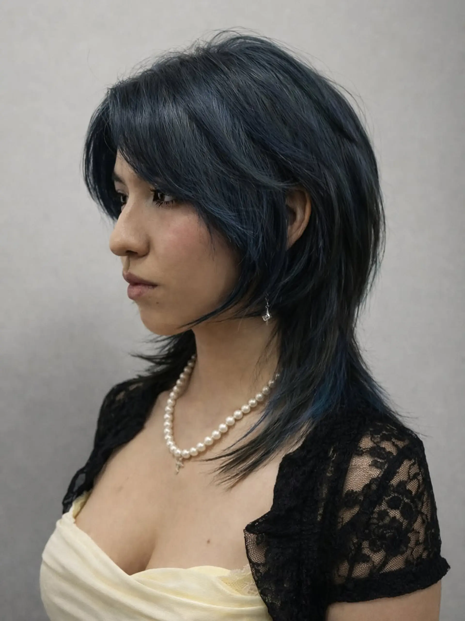 A textured shag-mullet hybrid with choppy, face-framing layers and distinct length variation, characterized by high-volume crown layers and piecey ends. 1