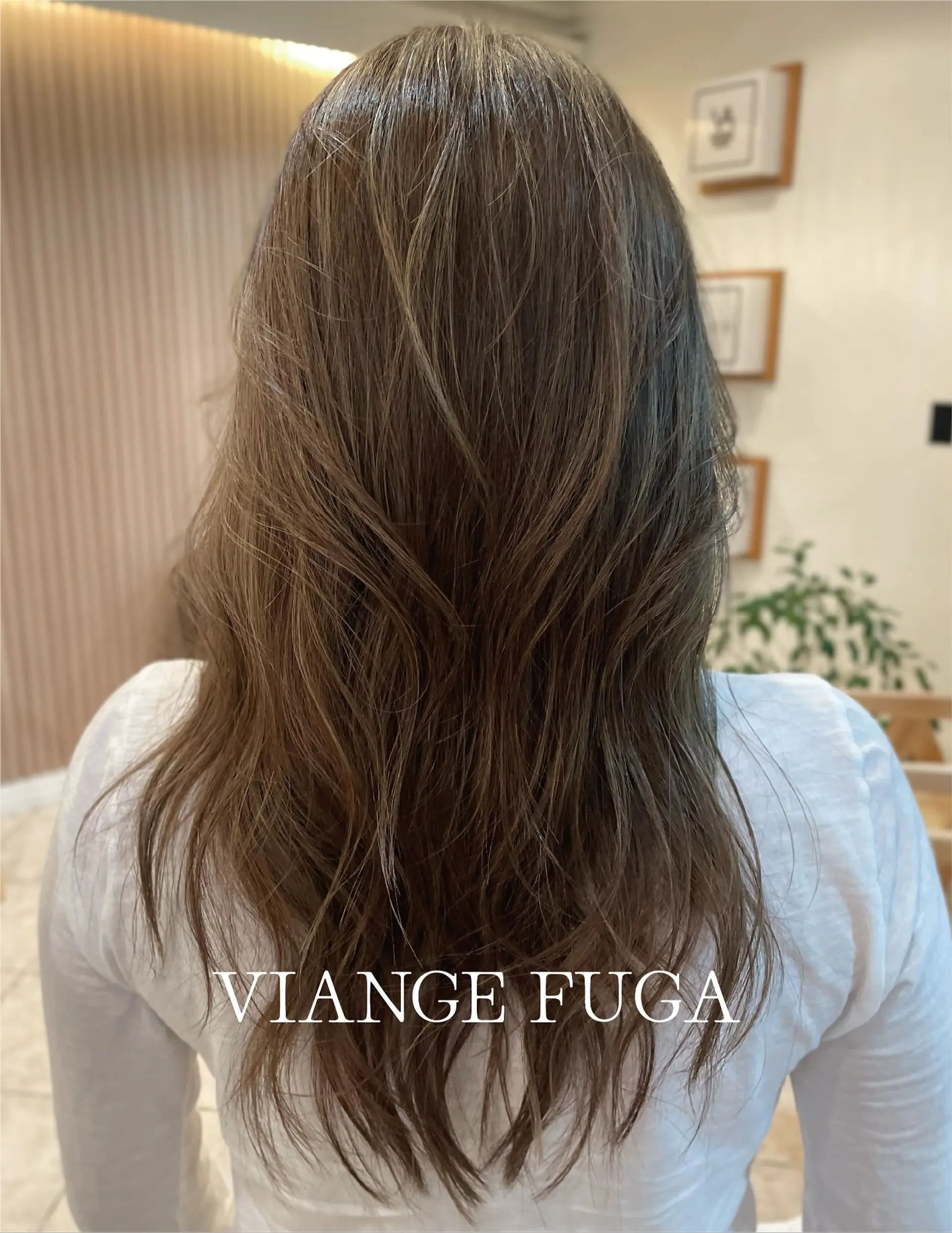 A long ash-brown layered cut styled with soft, touchable waves and natural movement. 1