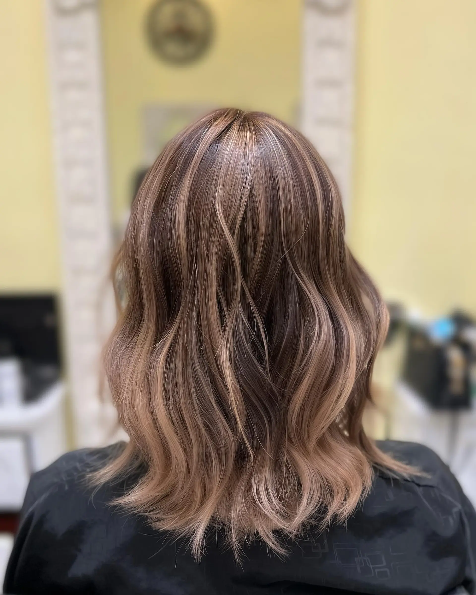 A trendy bronde wavy lob with lots of volume and movement. 2