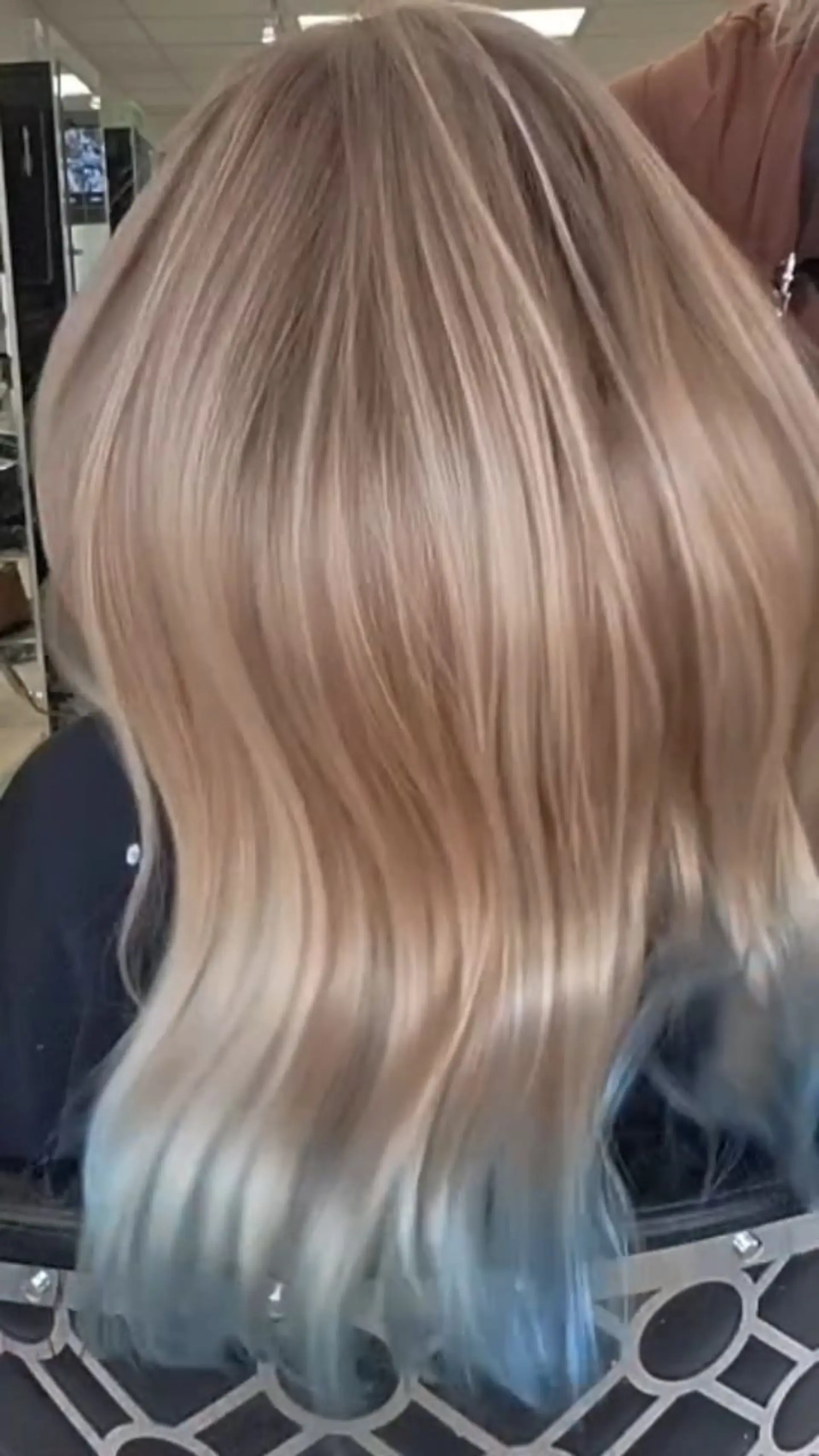 Smooth blonde balayage with soft waves and subtle pastel blue tips. 1