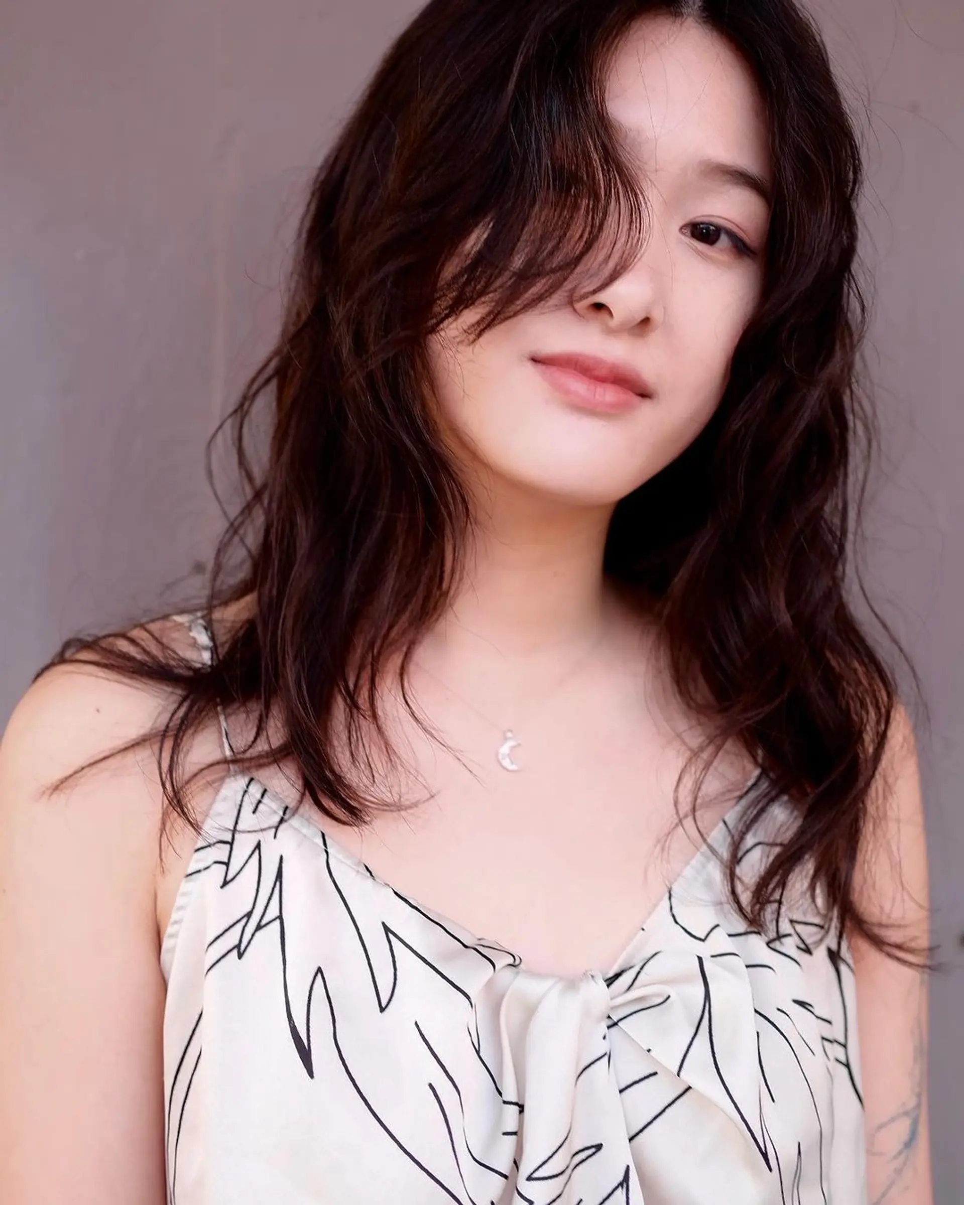 Long, wavy black hair with face-framing layers and a loose, natural texture. 2