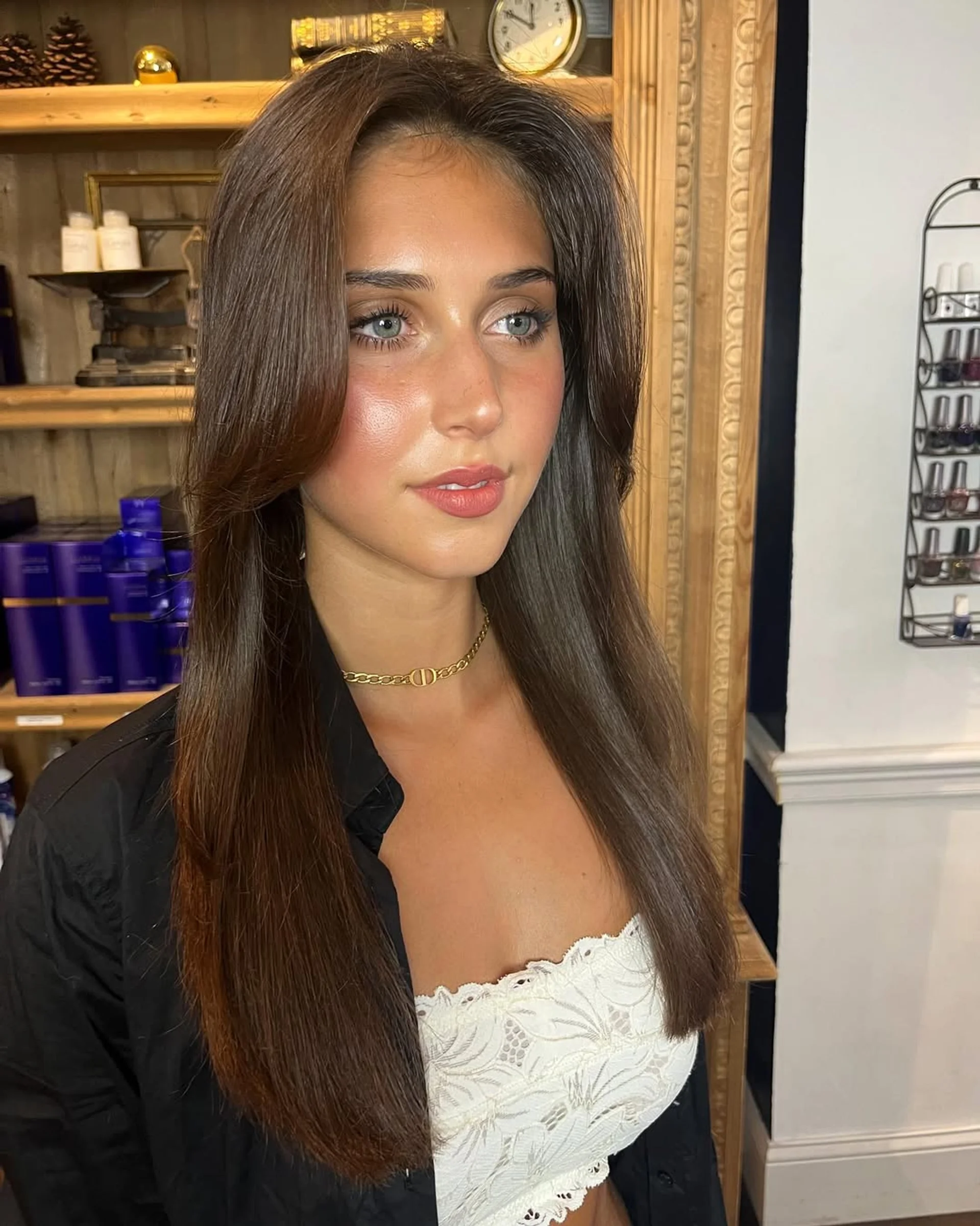 A woman with long wavy blonde hair featuring soft, voluminous ghost layers and face-framing pieces, a key 2025 NYC hair trend for fine hair. - Preview 3