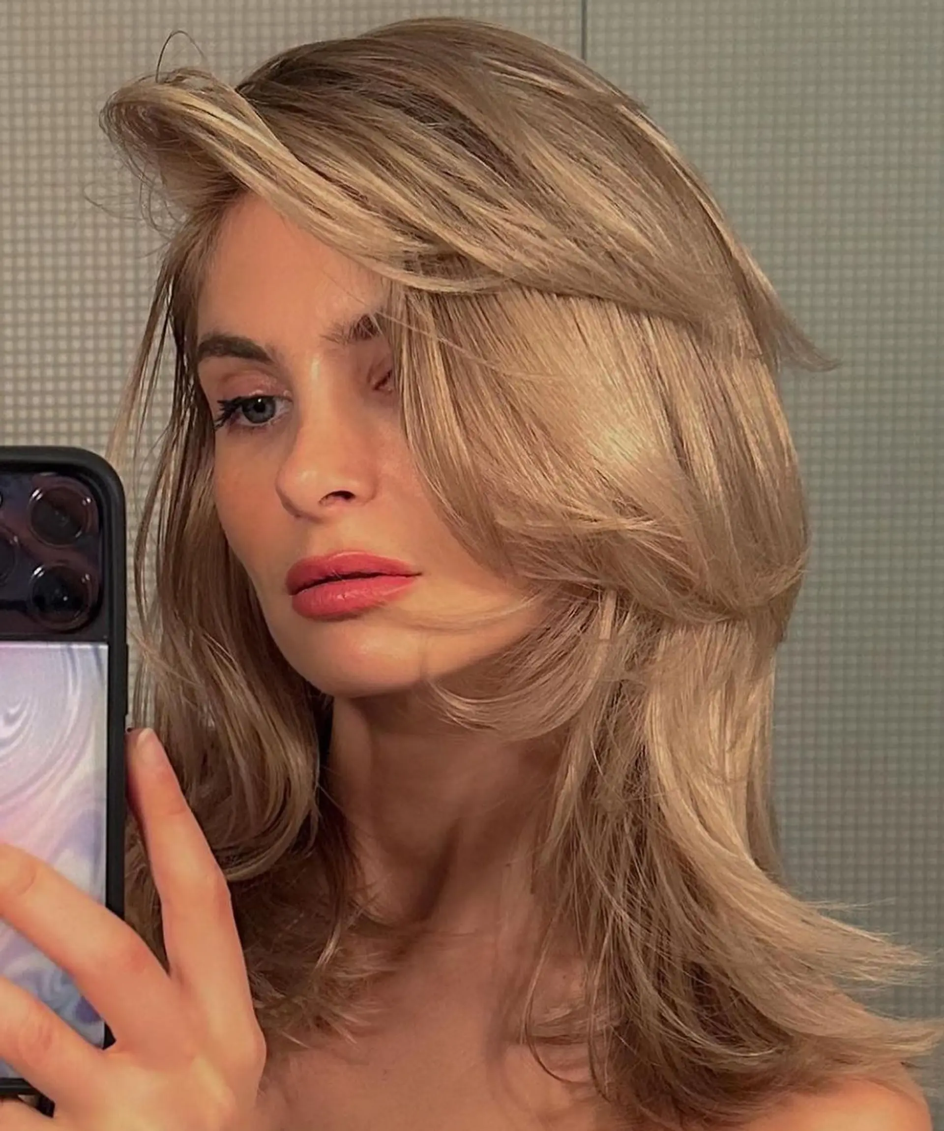 Medium-length, wavy hair with side-swept layers and a voluminous blonde, golden hue. 1