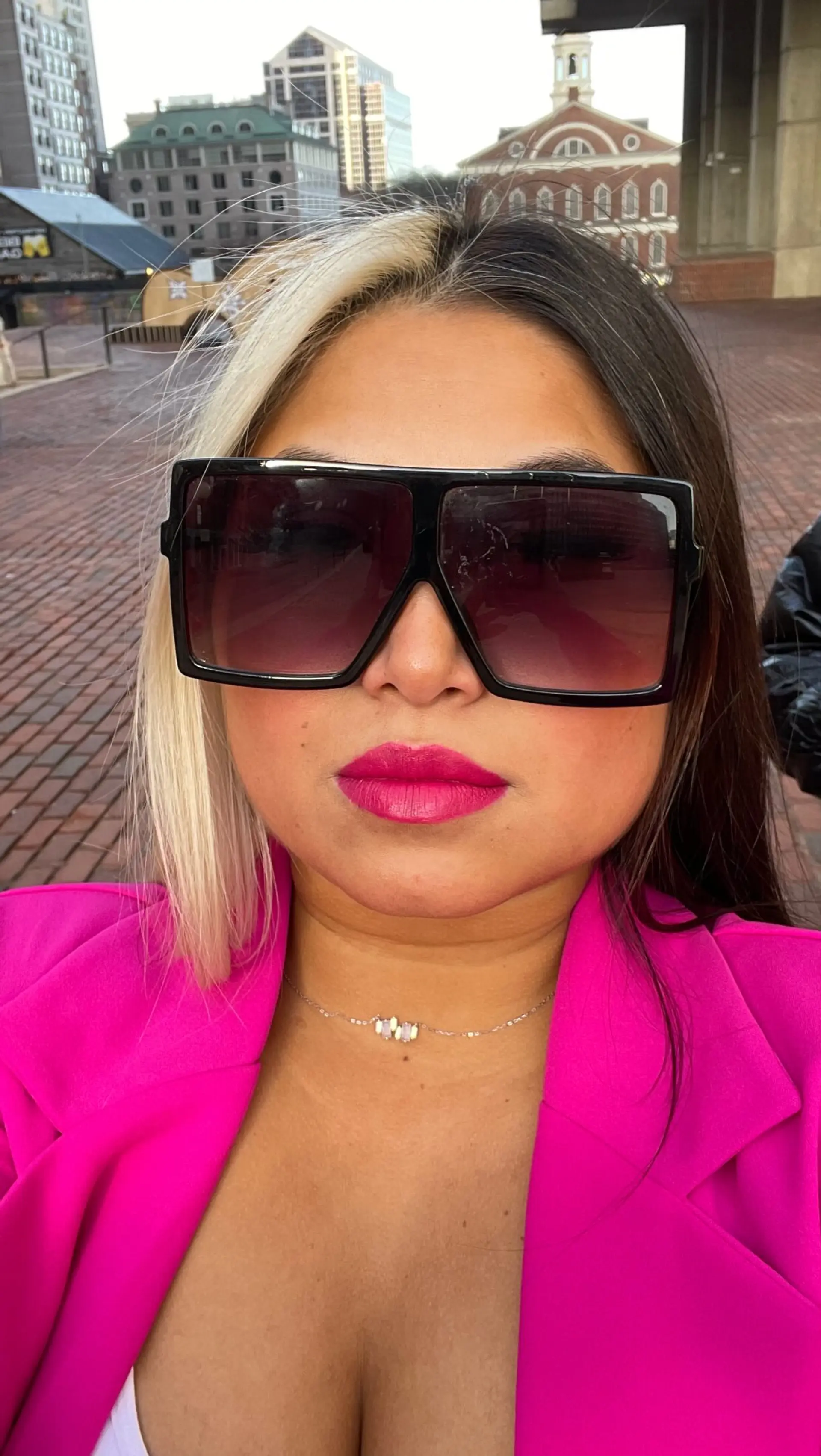 A bold split-dyed hairstyle featuring cool platinum blonde on one side and natural deep dark brunette on the other, styled sleek and straight. 1