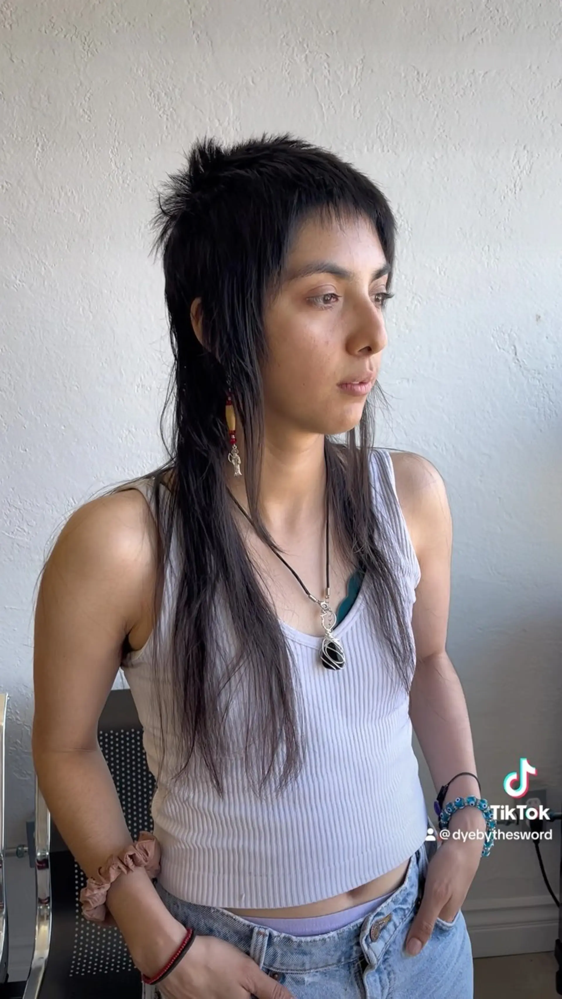 A textured punk mullet with choppy micro bangs, spiky crown layers, and long wispy front and back lengths. 1