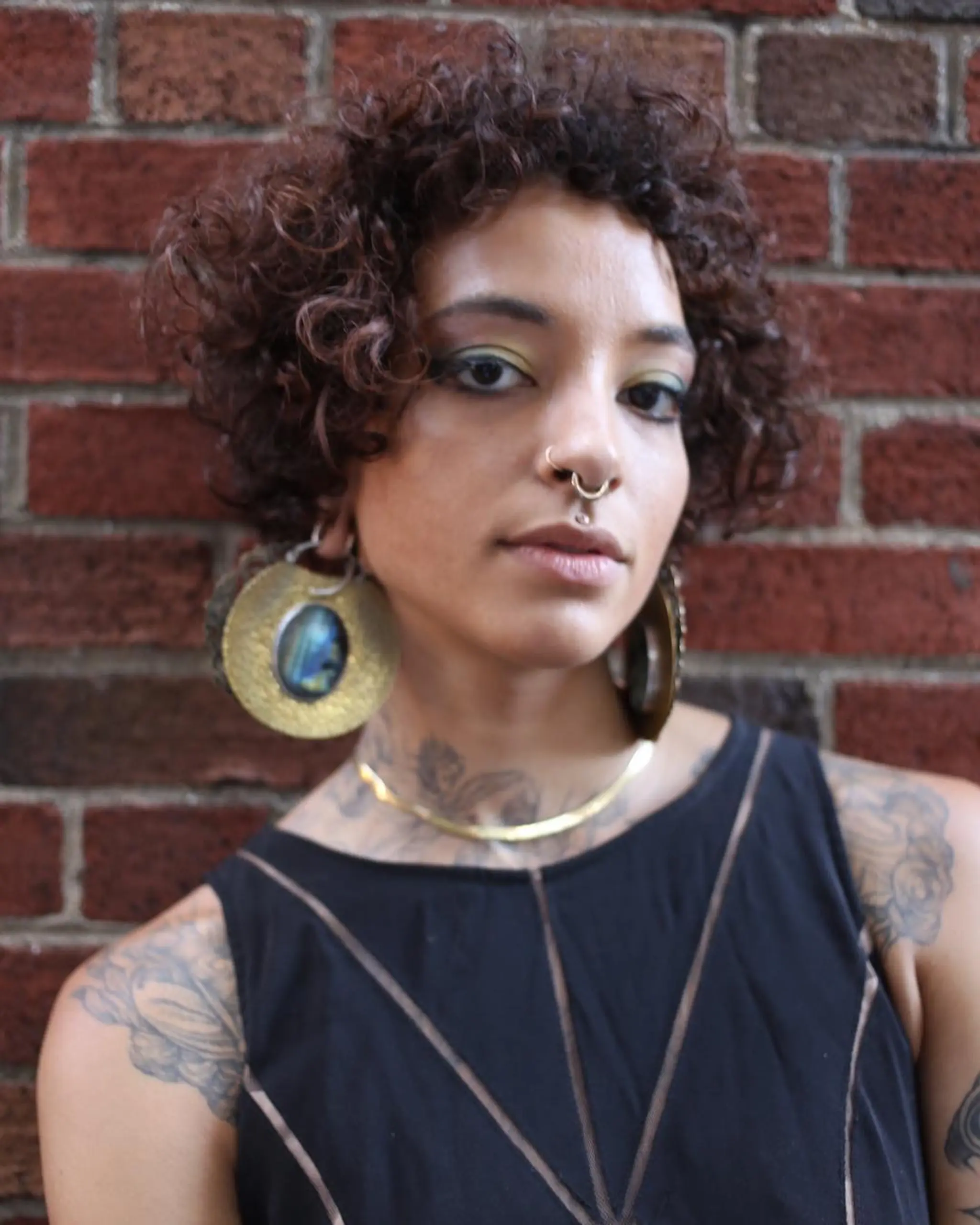 Stylish short curly hair with voluminous brown ringlets, adding a dynamic and textured look.