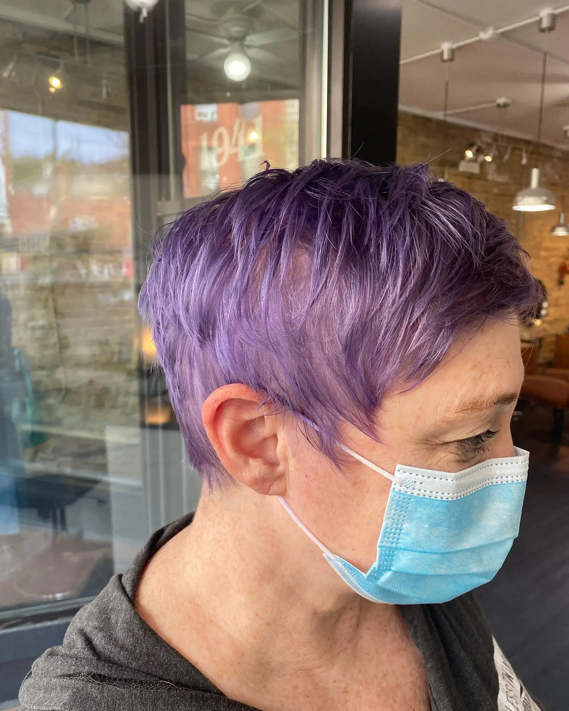 A textured, piecey pixie cut featuring a vibrant pastel purple lavender color with soft fringe framing the face. 1