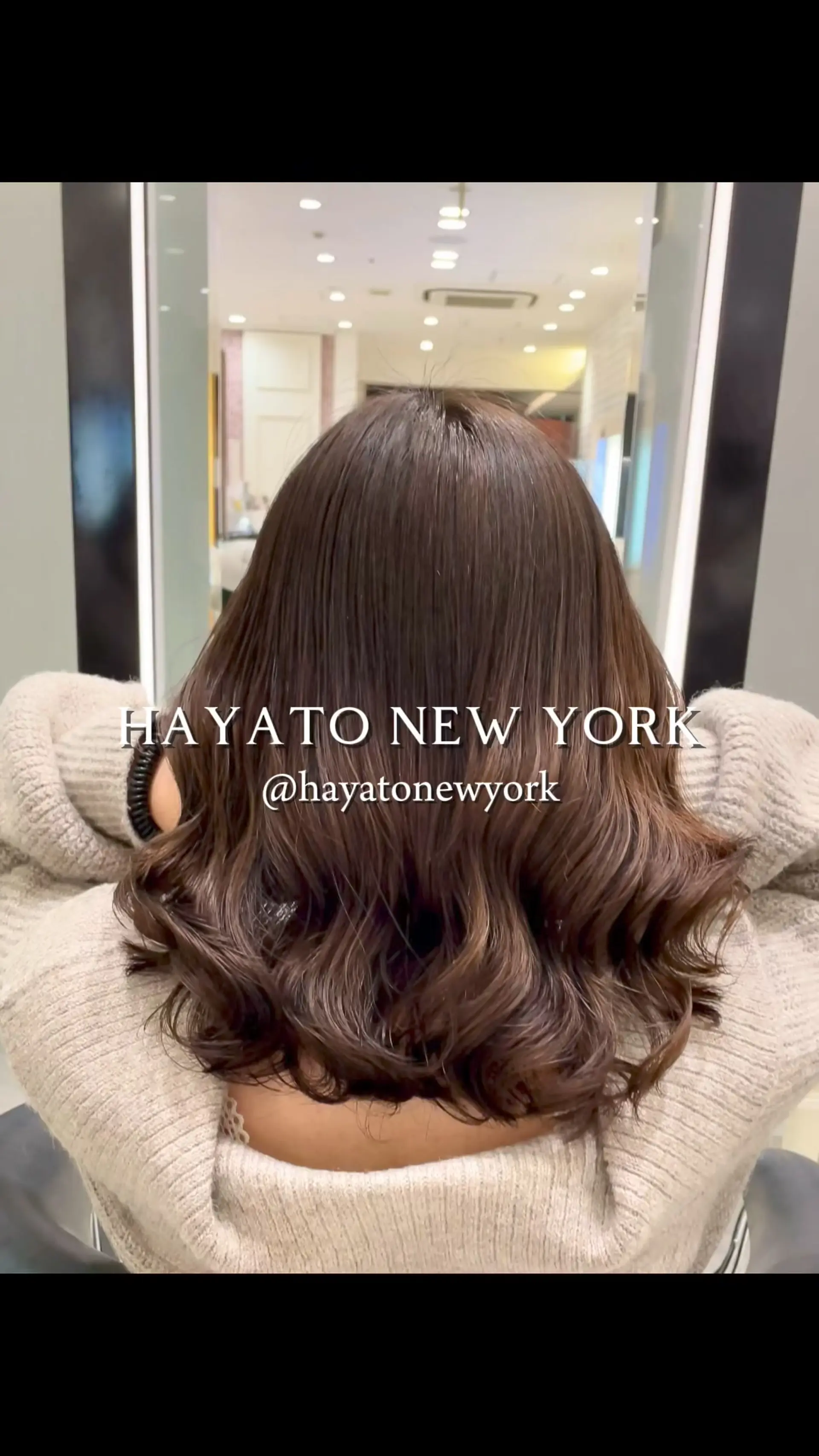 Medium-length chestnut brown hair styled with smooth roots and bouncy, soft curls at the ends. 1