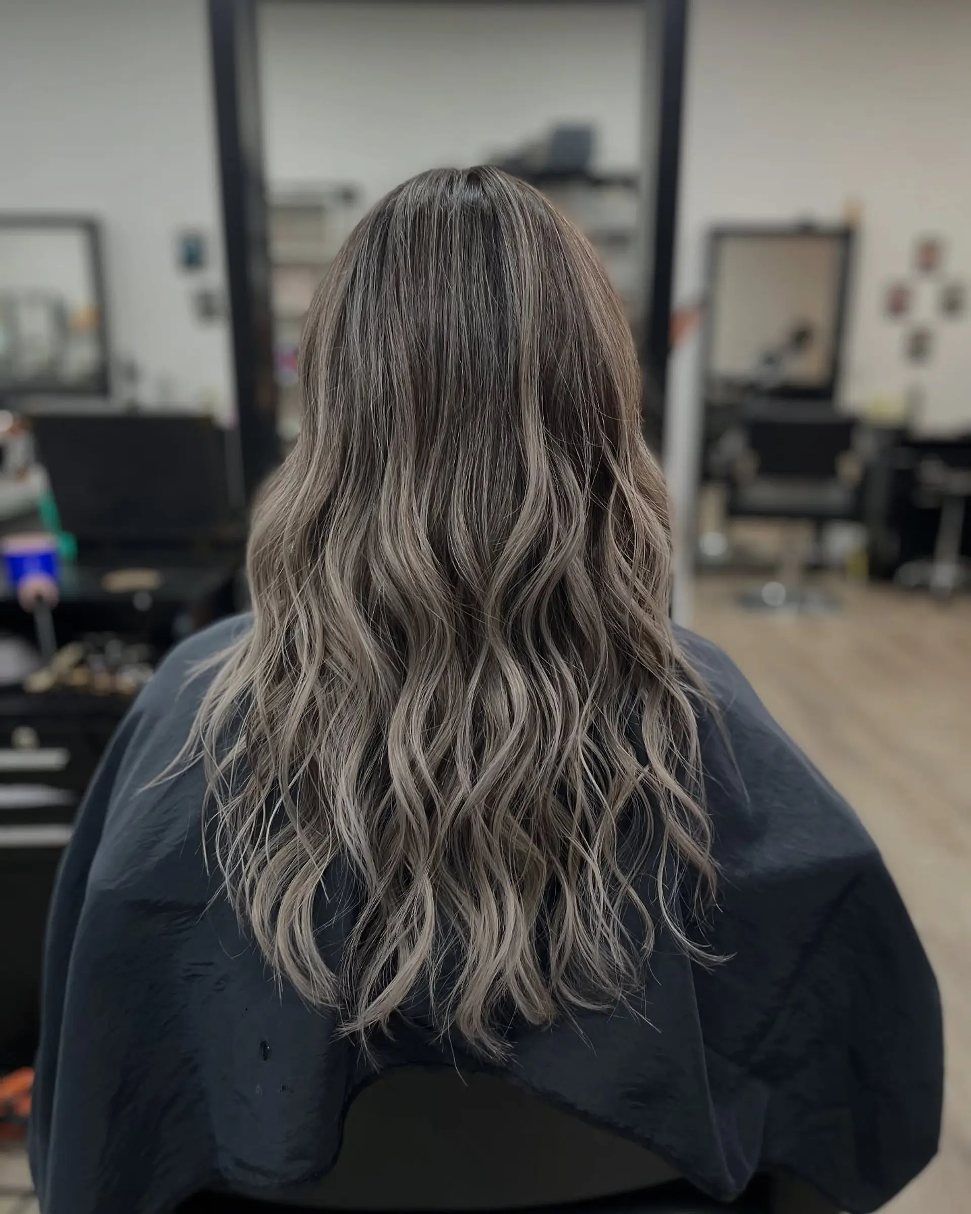 Long, wavy hair with a seamless ash blonde balayage. 1