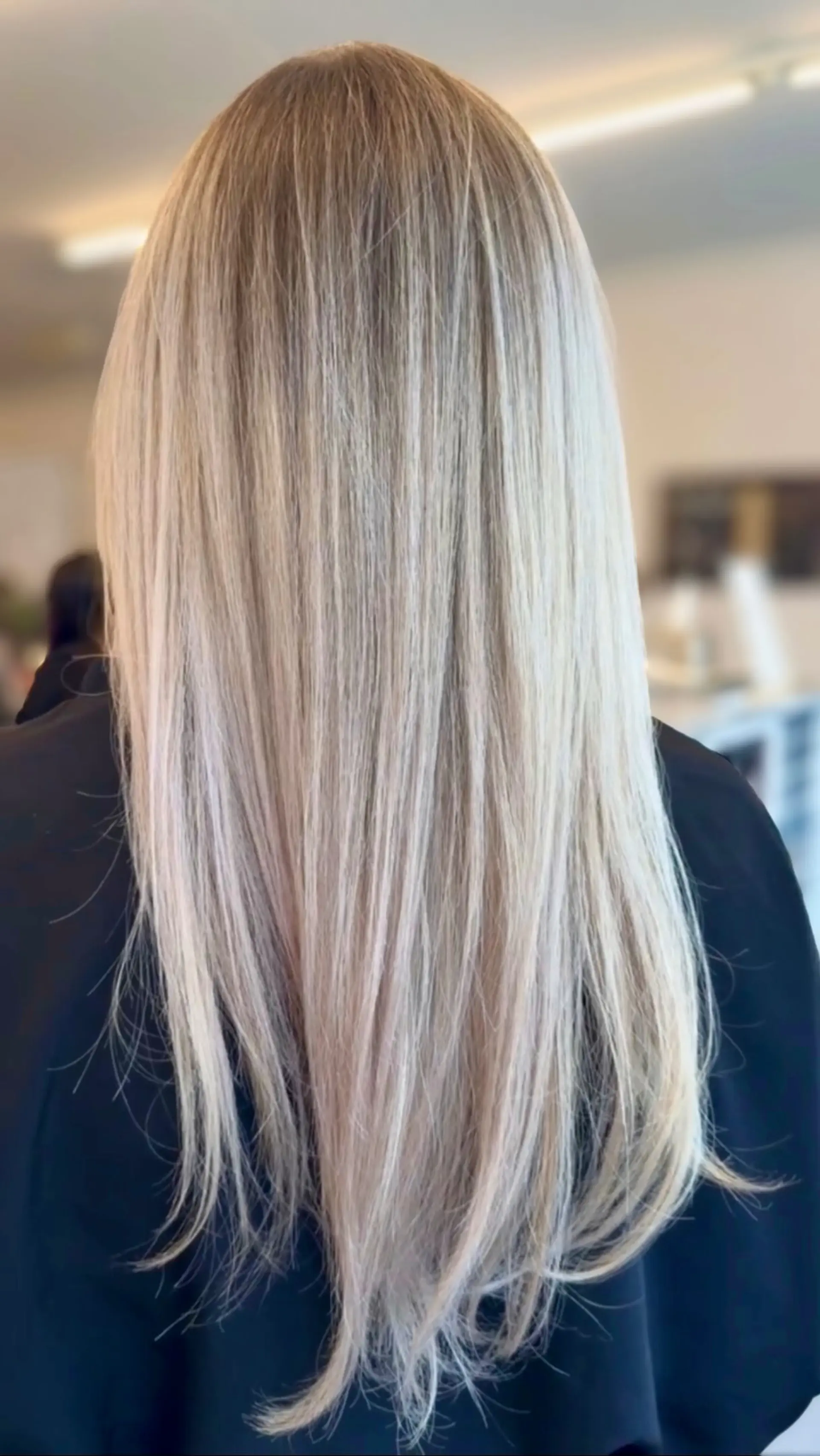 Long, sleek, straight platinum blonde hair with a smooth finish. 1
