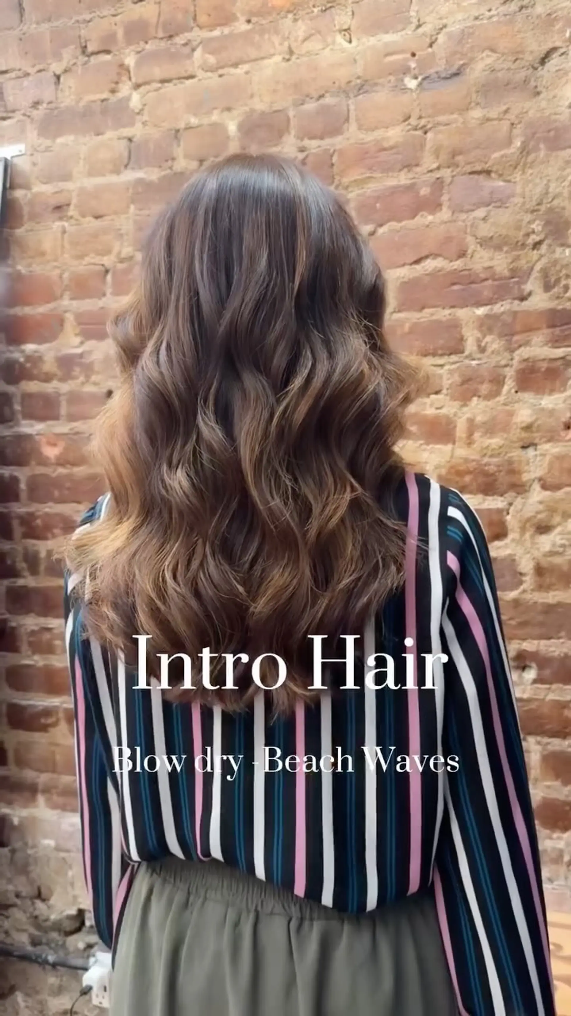 Long dimensional brunette hair styled in loose, glossy beach waves. 1