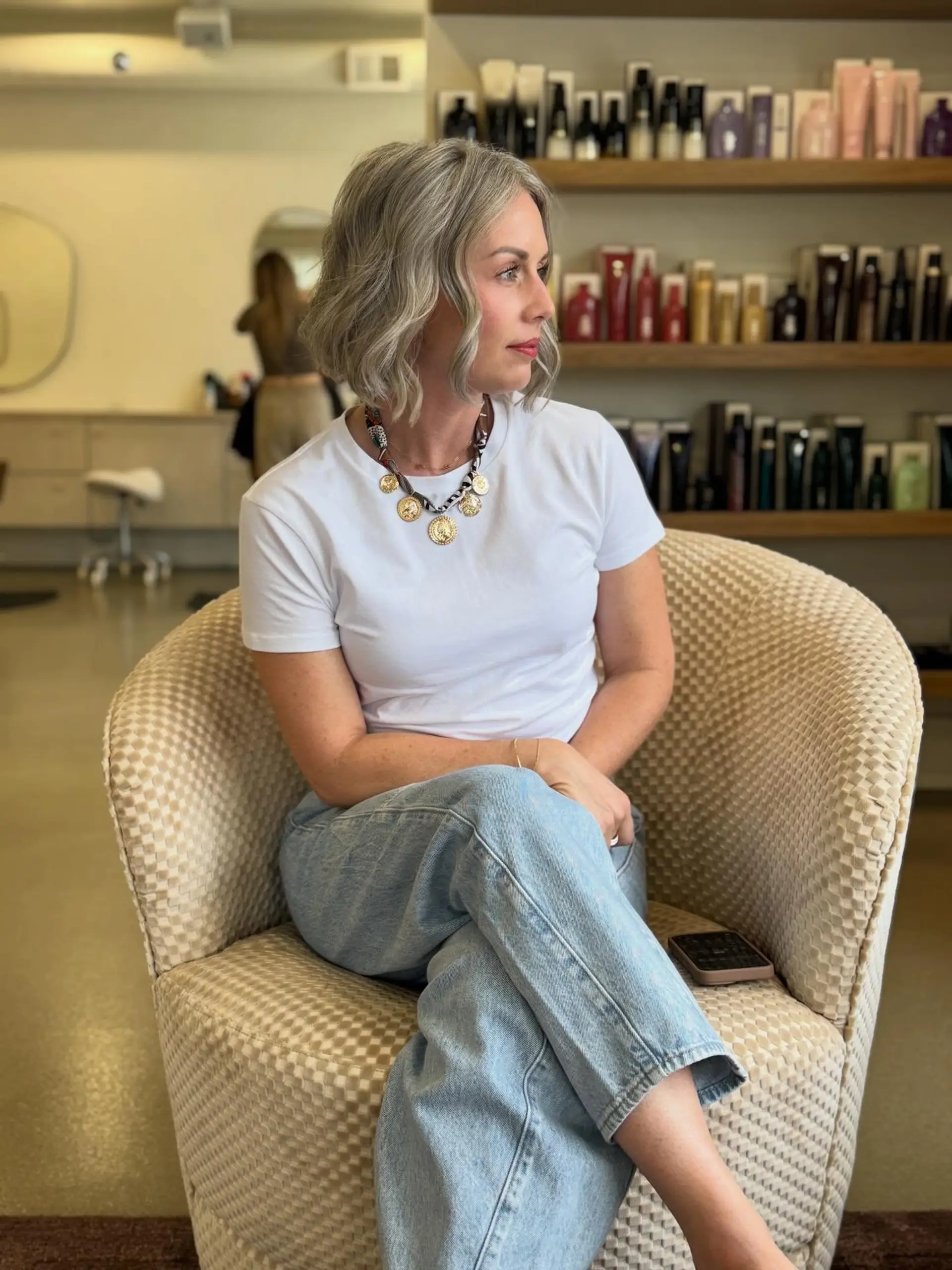 A chin-length textured bob with loose waves in a cool silver-grey tone. 1