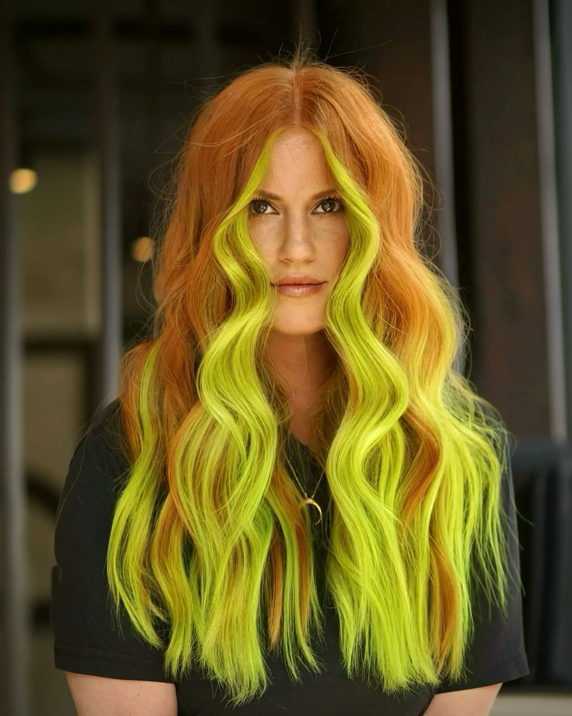 Long flowing copper hair styled in soft textured waves with a bold, high-contrast neon green face-framing money piece. 1