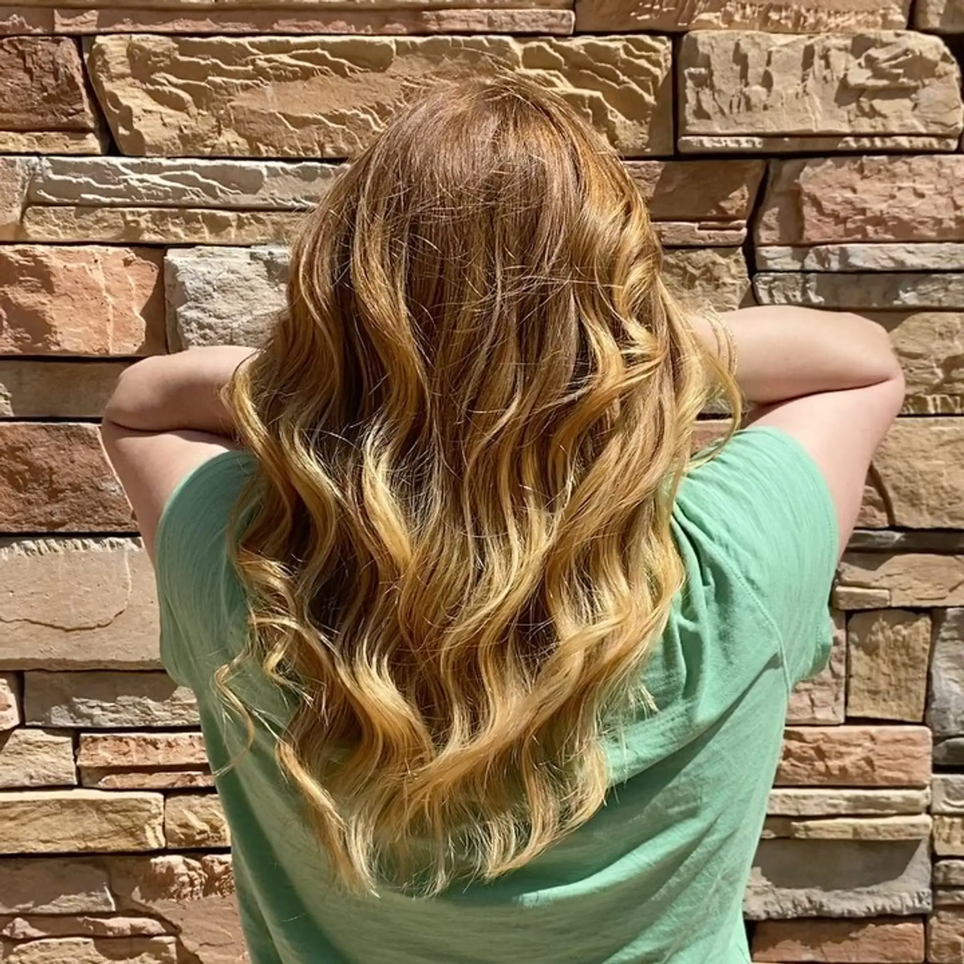 Dimensional strawberry and golden blonde hair styled in loose, soft waves cascading down the back. 1
