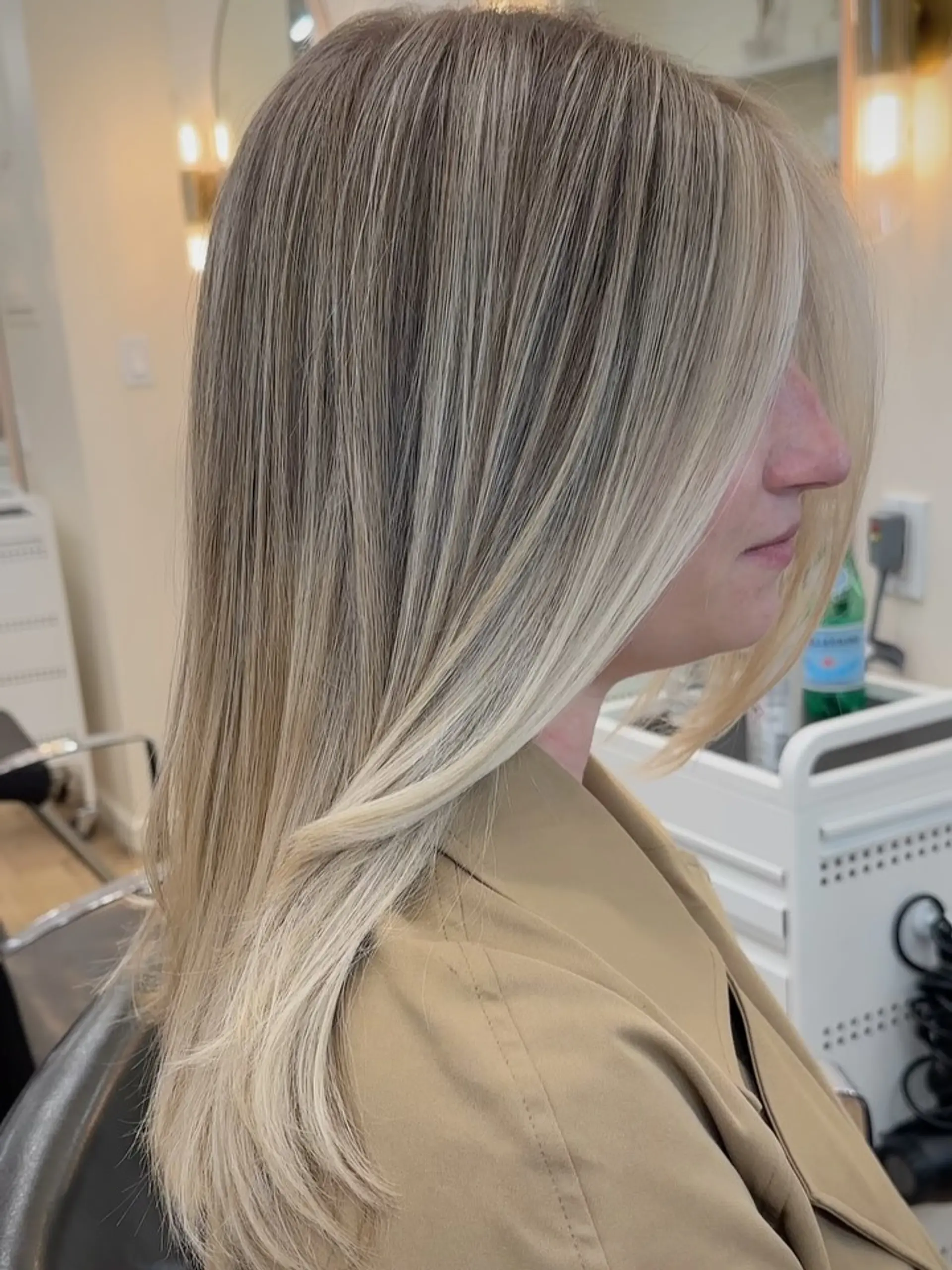 A sleek, straight long blonde style featuring fine dimensional highlights blended with a soft natural base and a bright face-framing fringe section. 1