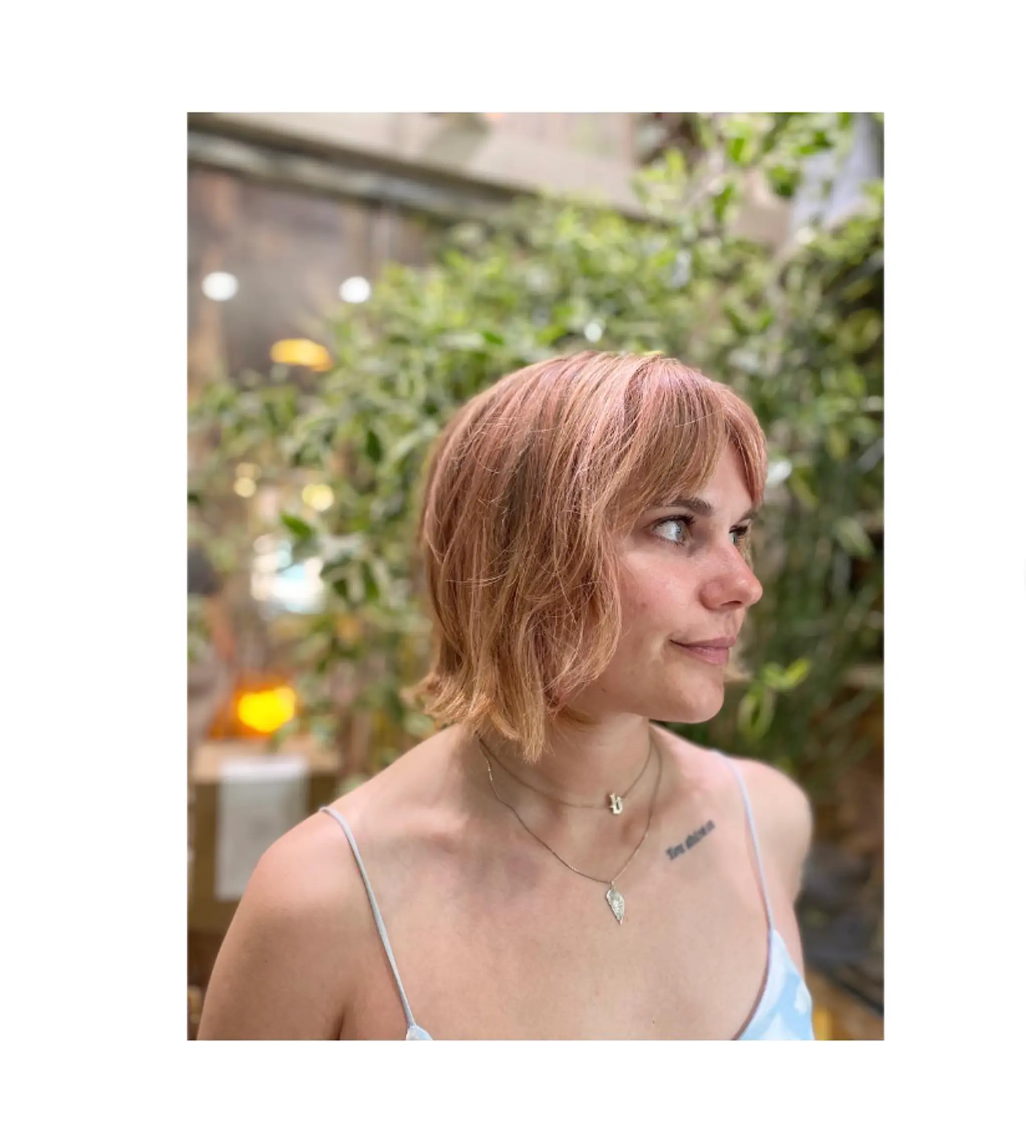 A short, blunt bob with textured ends and baby bangs.