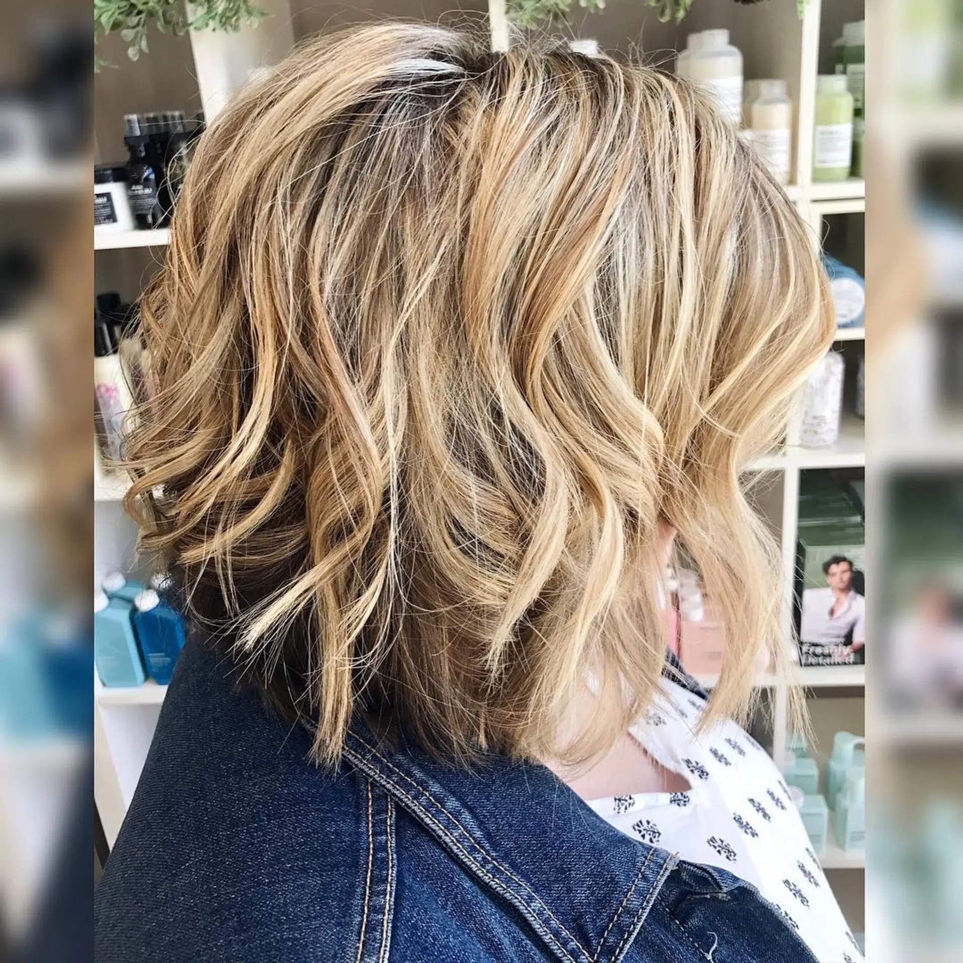 A textured short bob haircut featuring multi-dimensional blonde highlights styled in loose, tousled waves. 1
