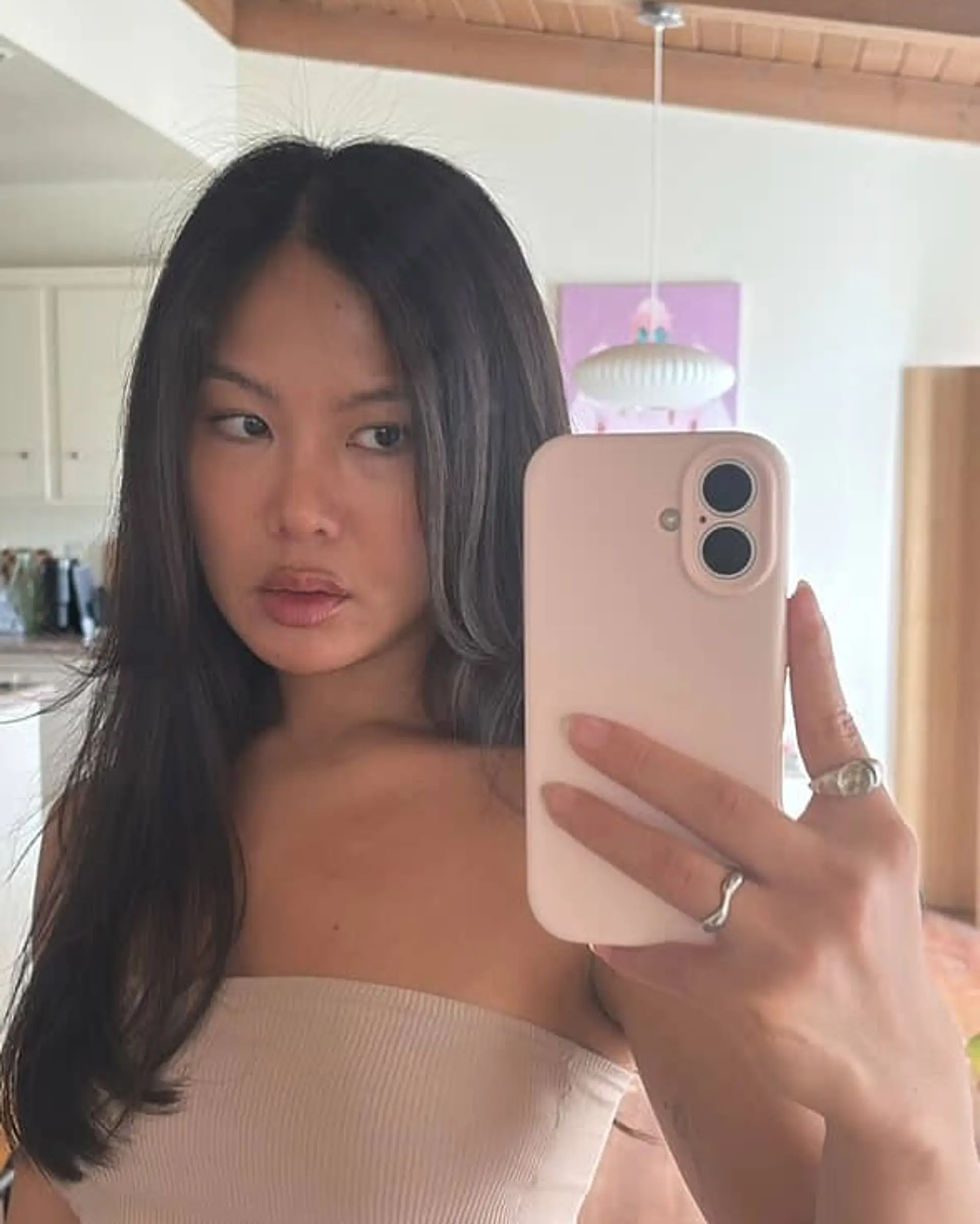 This layered haircut features long, straight hair with face-framing curtain bangs. 1